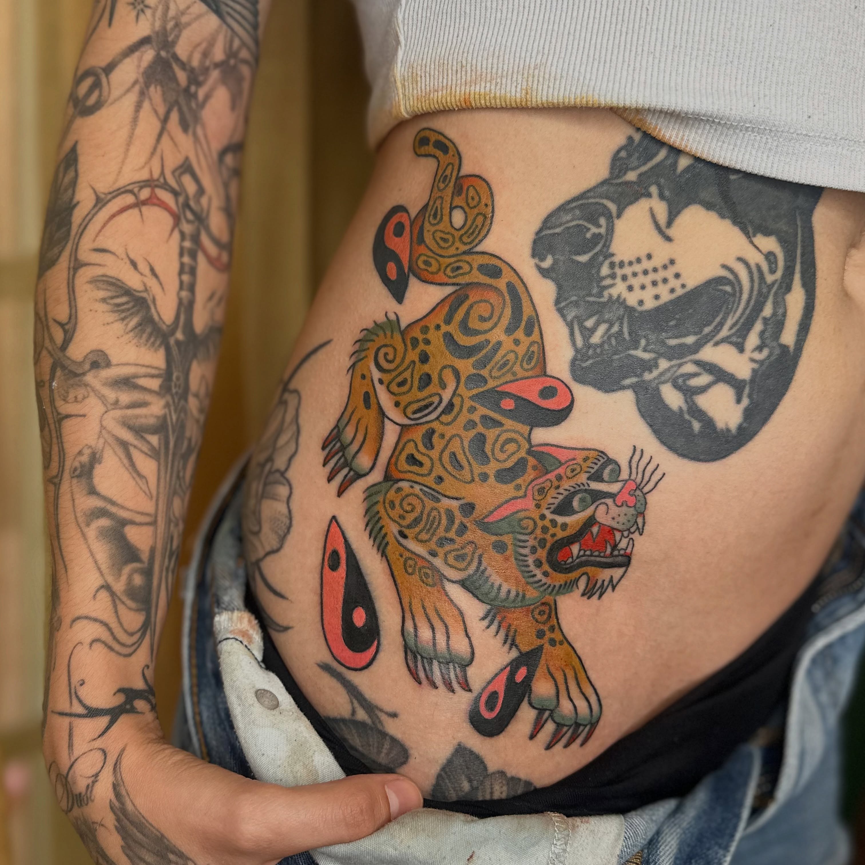 Jaguar American traditional tattoo on the ribs by Brieana Smith