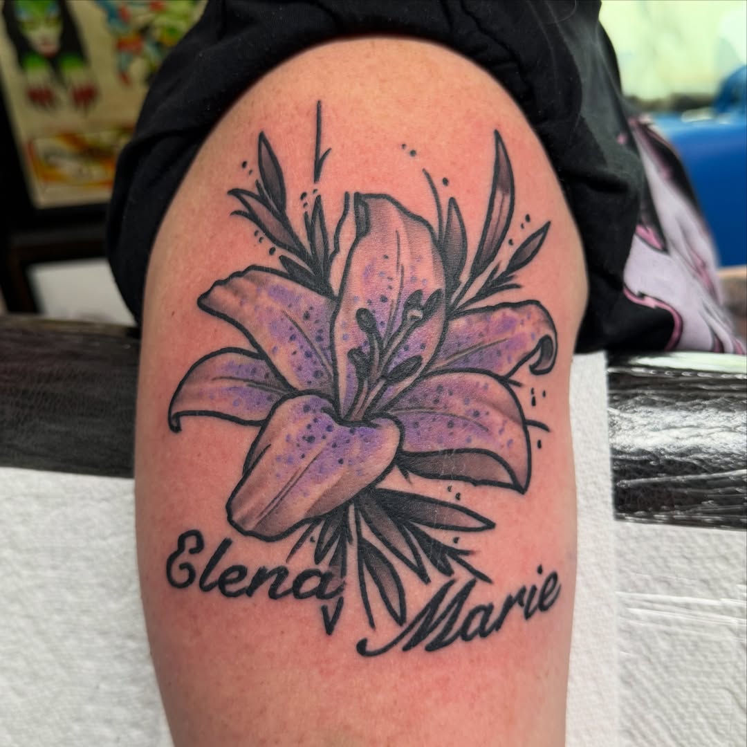 Lily dotwork tattoo on the upper arm by Will Eagle
