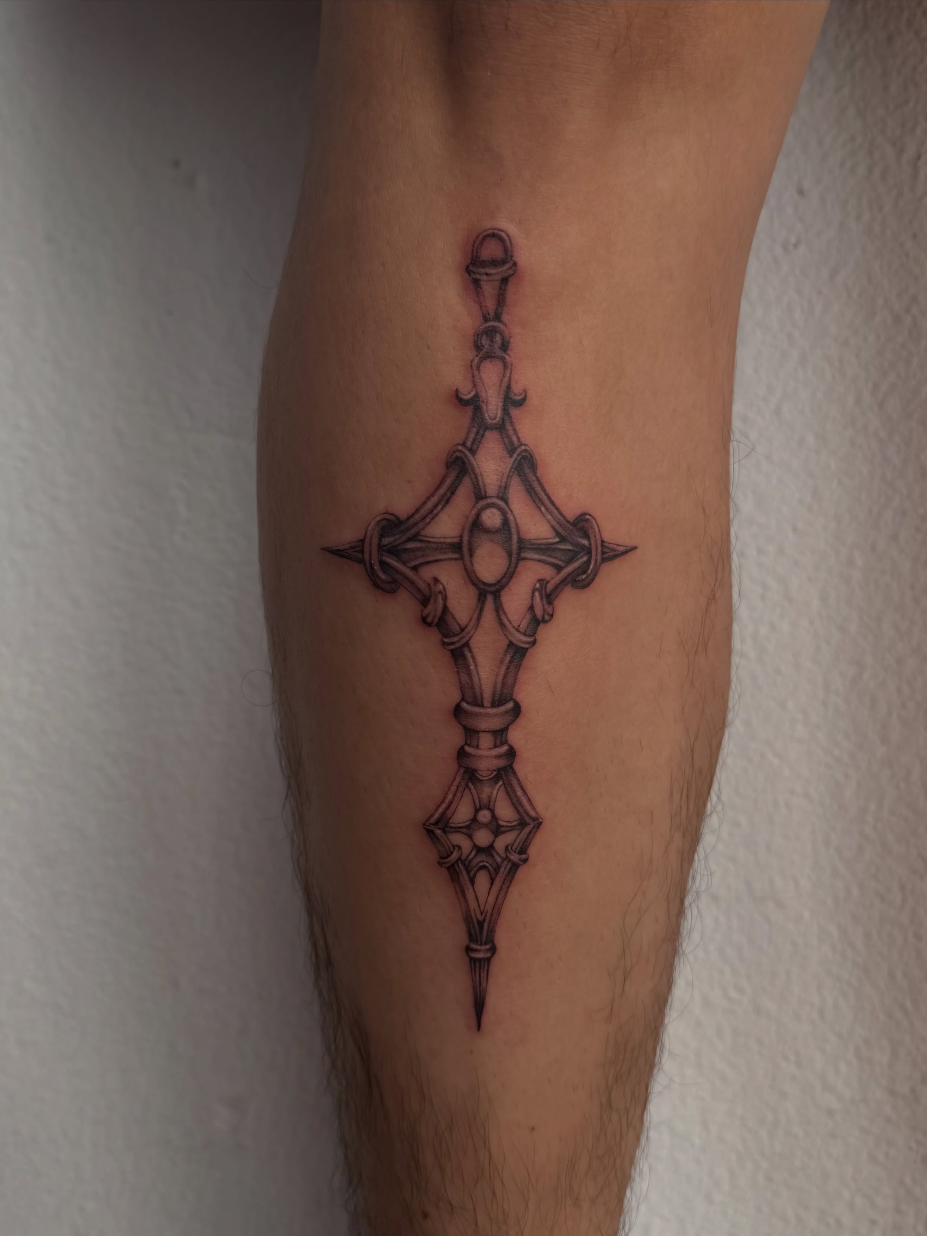 Cross geometric tattoo on the forearm by Lauren ๐