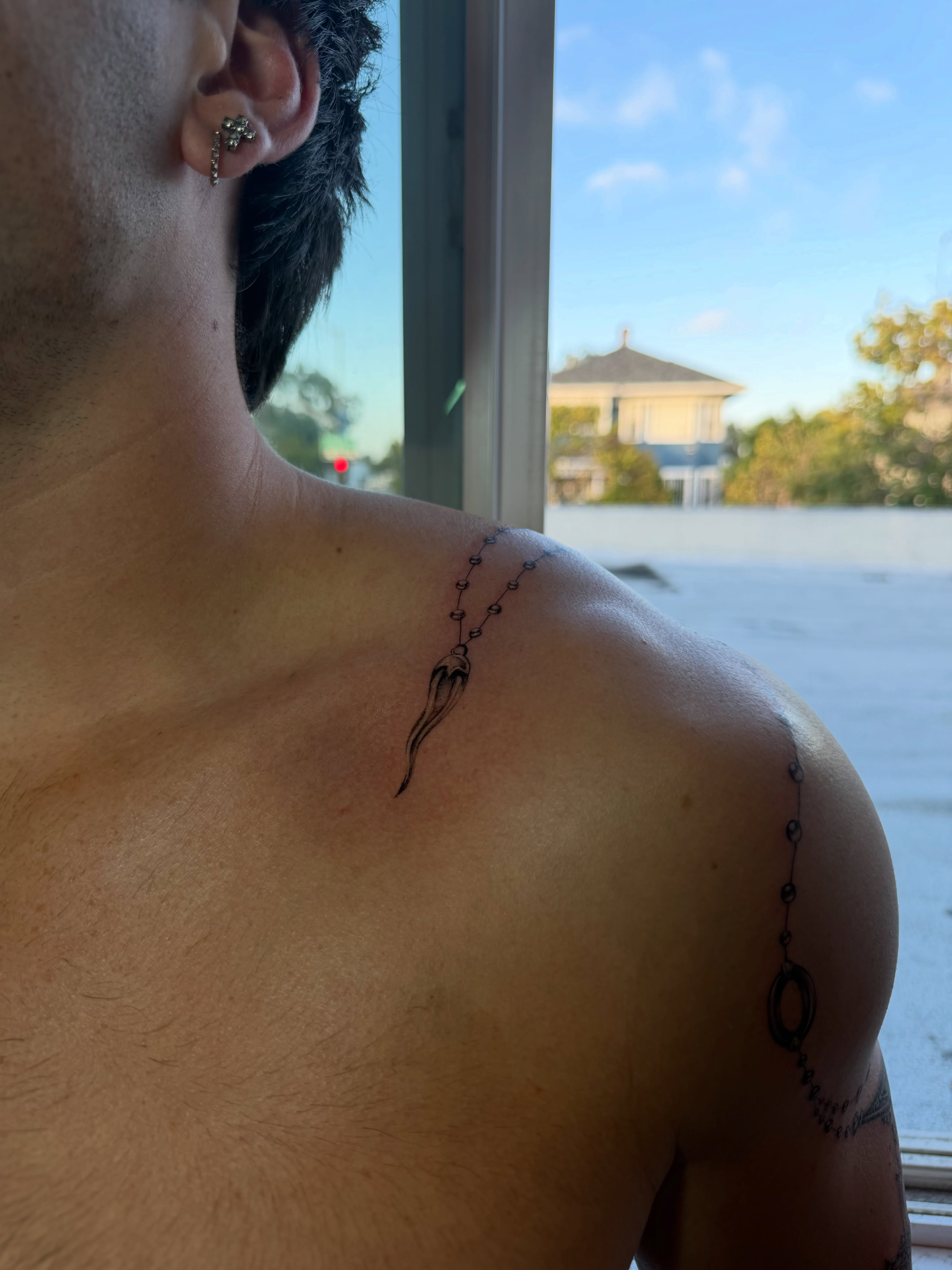 Rosary black and grey tattoo on the shoulder by Lauren ๐