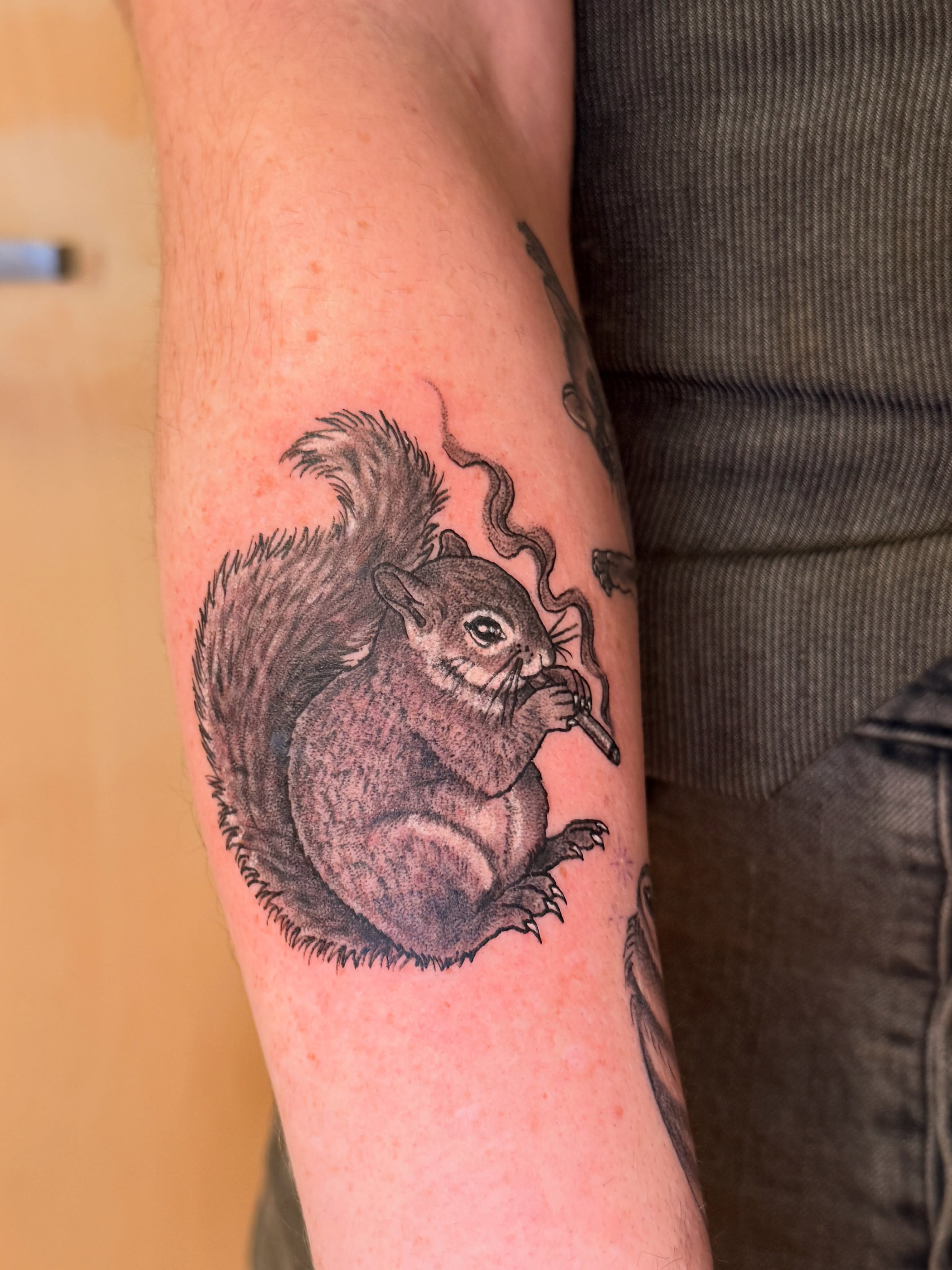 Squirrel smoking realism tattoo on the forearm by Ty Hamilton