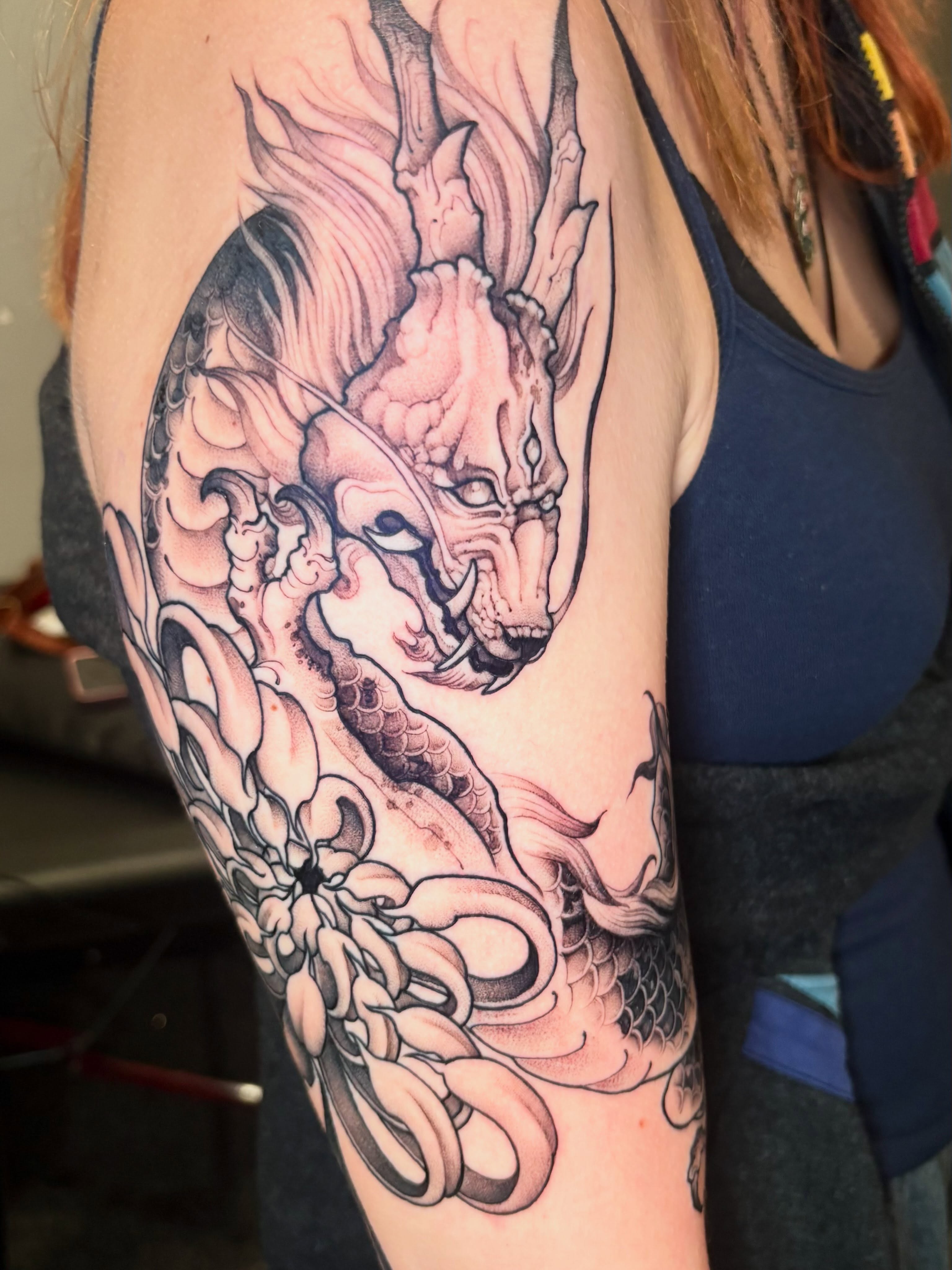Dragon japanese irezumi tattoo on the upper arm by Eddie Wolfe