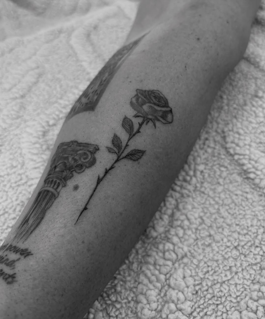 Rose and column black and grey tattoo on the forearm by @secretlinetattoo
