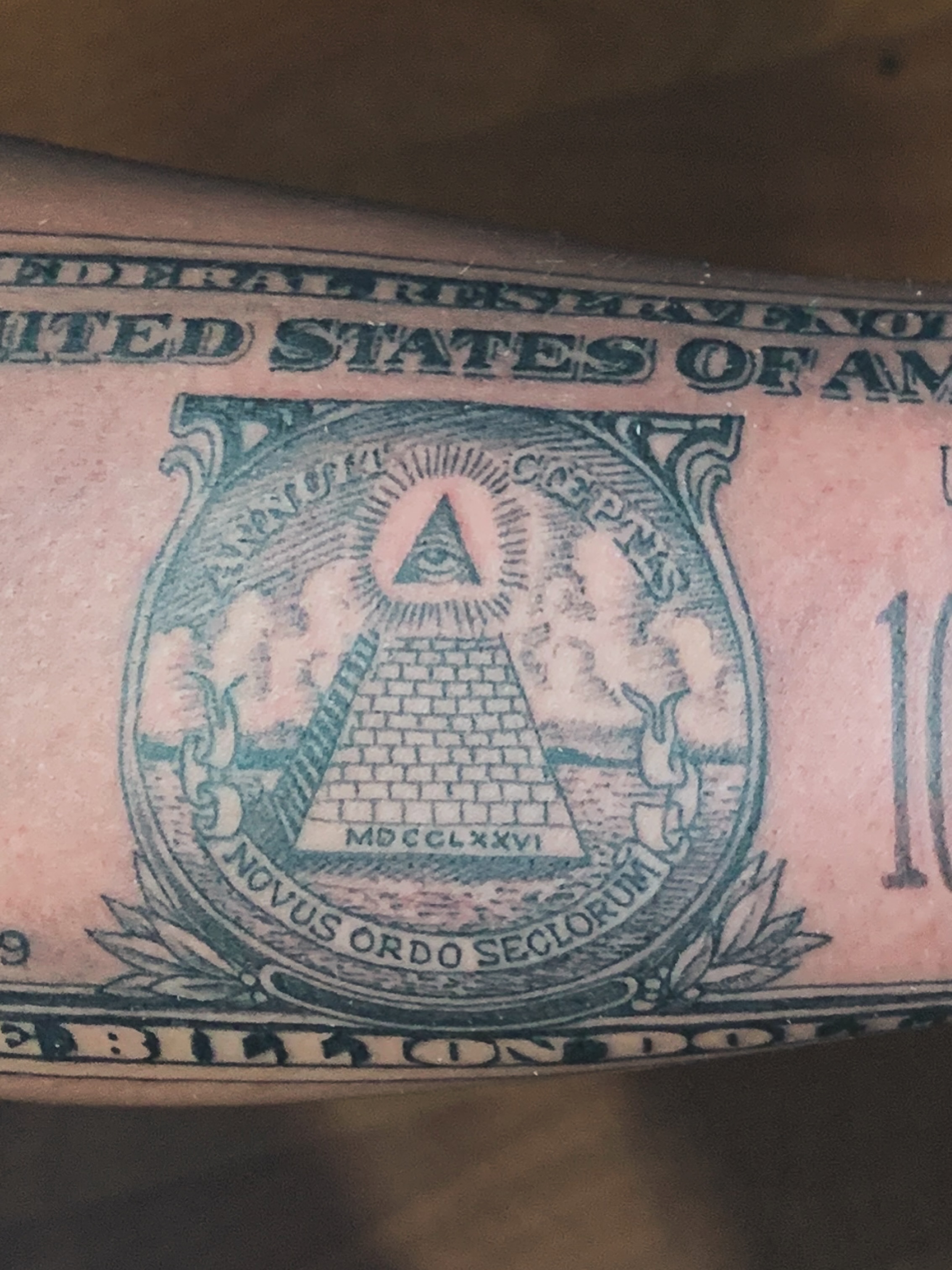 Dollar bill American traditional tattoo on the forearm by Rafael Marte, White Plains, New York