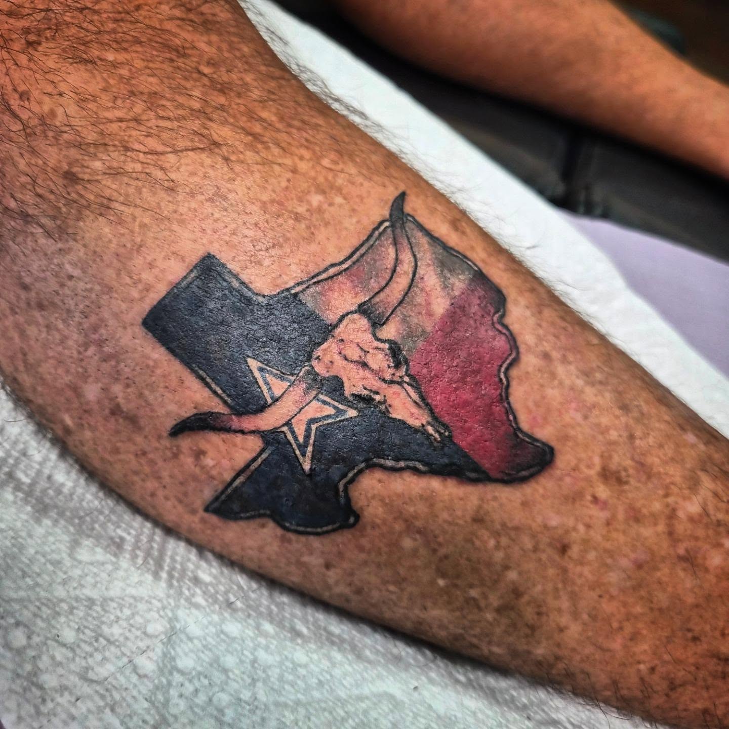 Bull skull and Texas flag American traditional tattoo on the forearm by Taylor Popkins