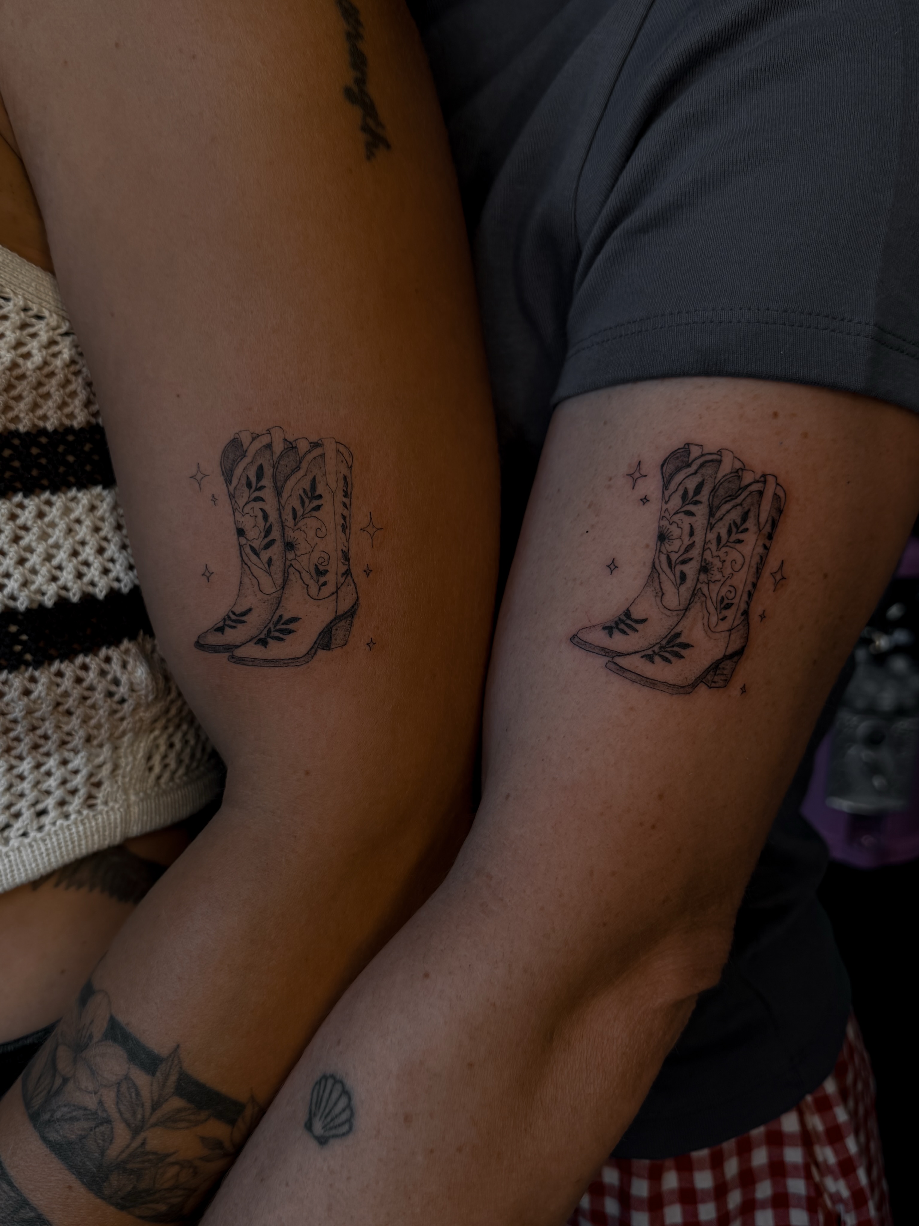 Cowboy boots black and grey tattoo on the forearm by Ryleigh Benjamin