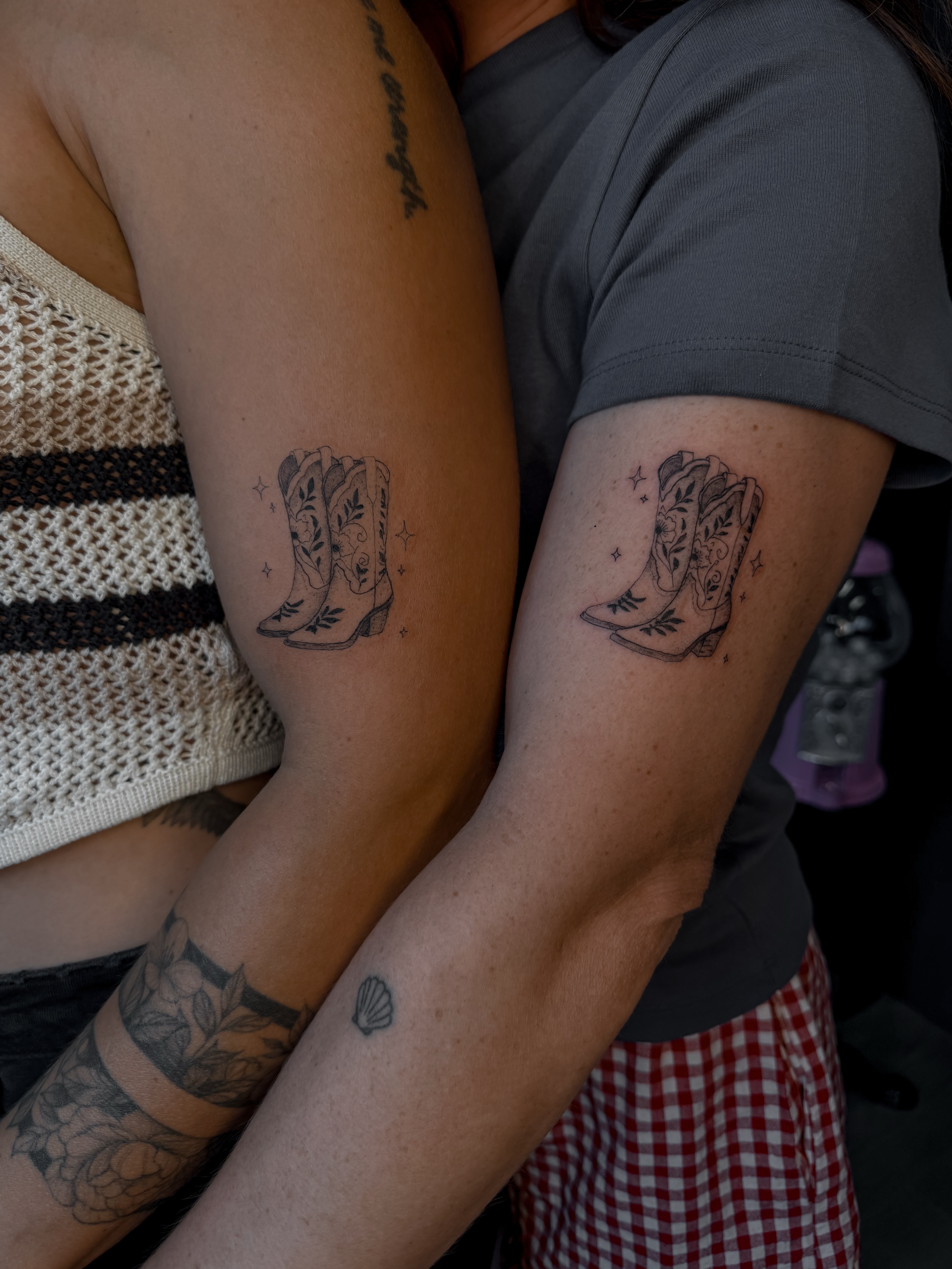 Cowboy boots black and grey tattoo on the forearm by Ryleigh Benjamin