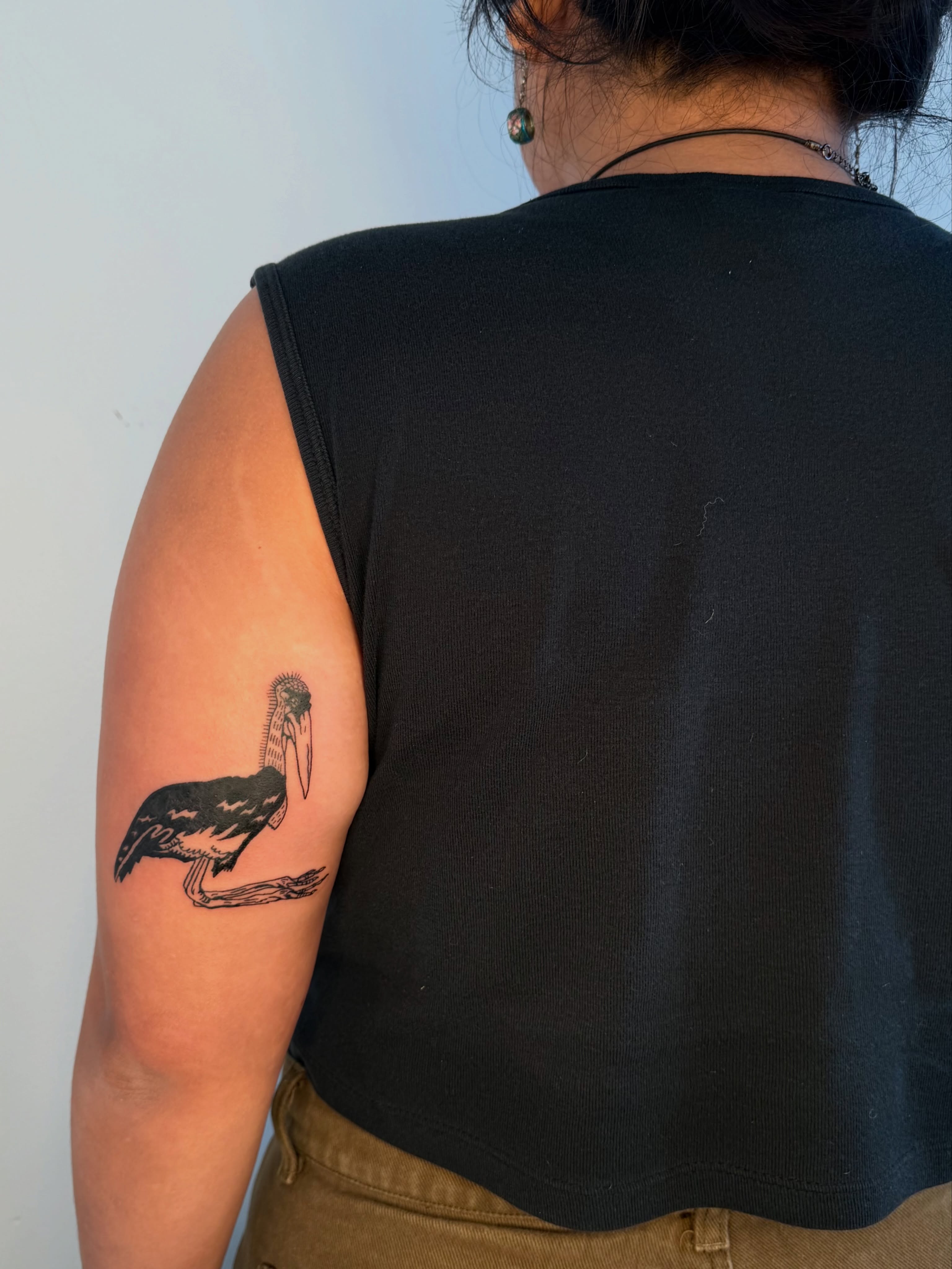 Pelican black and grey tattoo on the upper arm by ♤ Catherine Stengel ♤