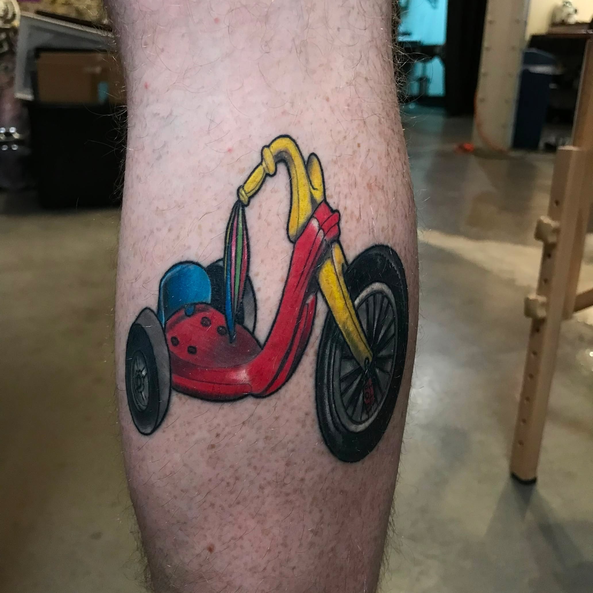 Motorcycle trash polka tattoo on the forearm by Bobby Trefz