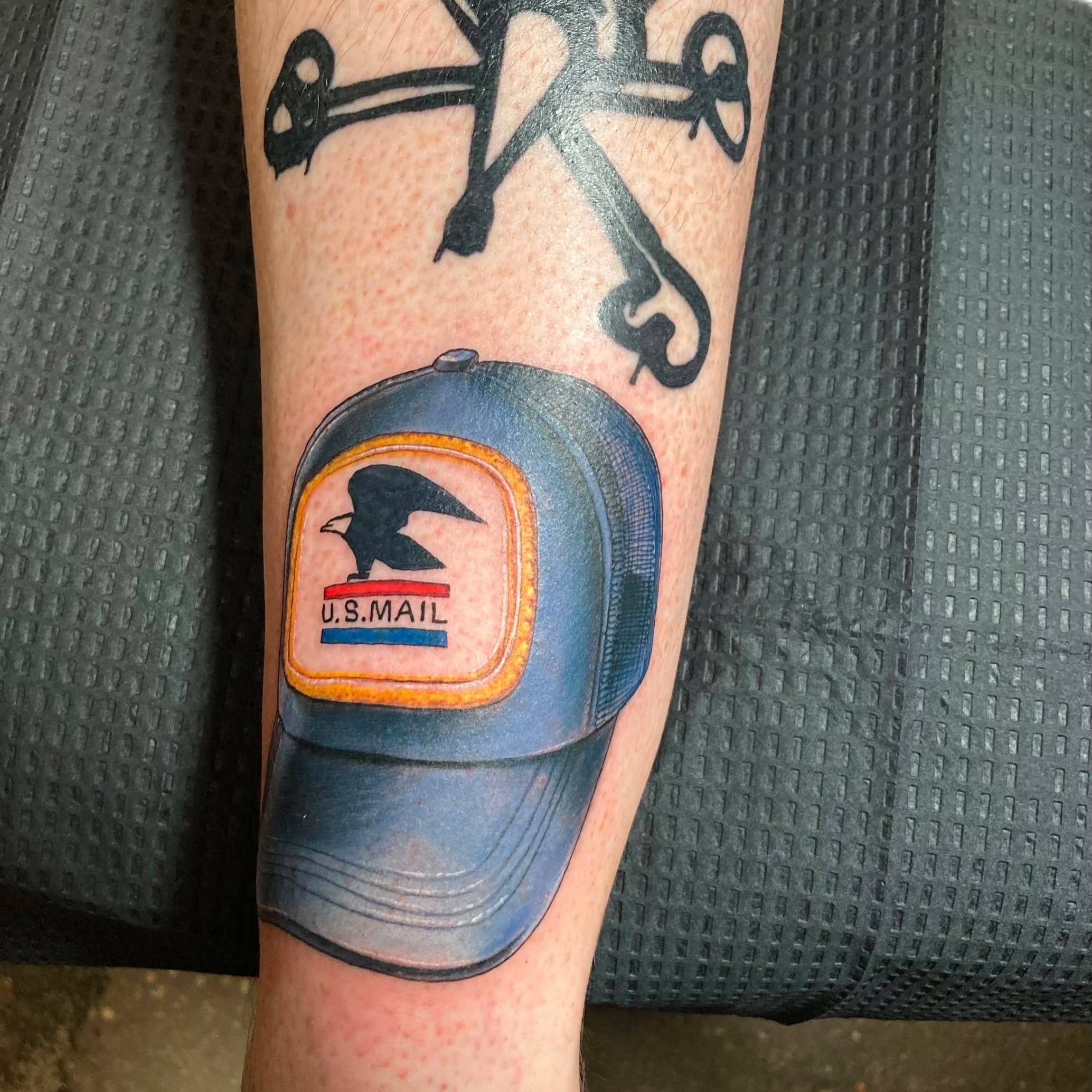 U.S. Mail hat realism tattoo on the forearm by Bobby Trefz