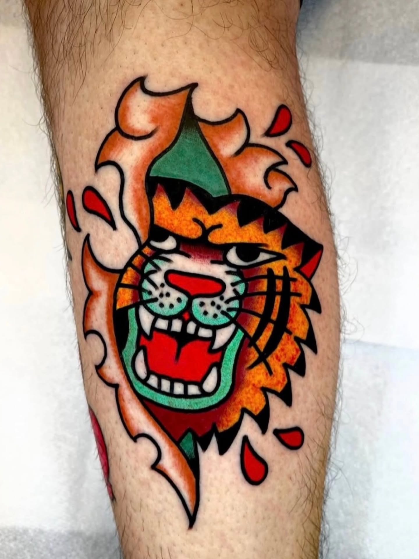 Tiger American traditional tattoo on the forearm by Don Lee