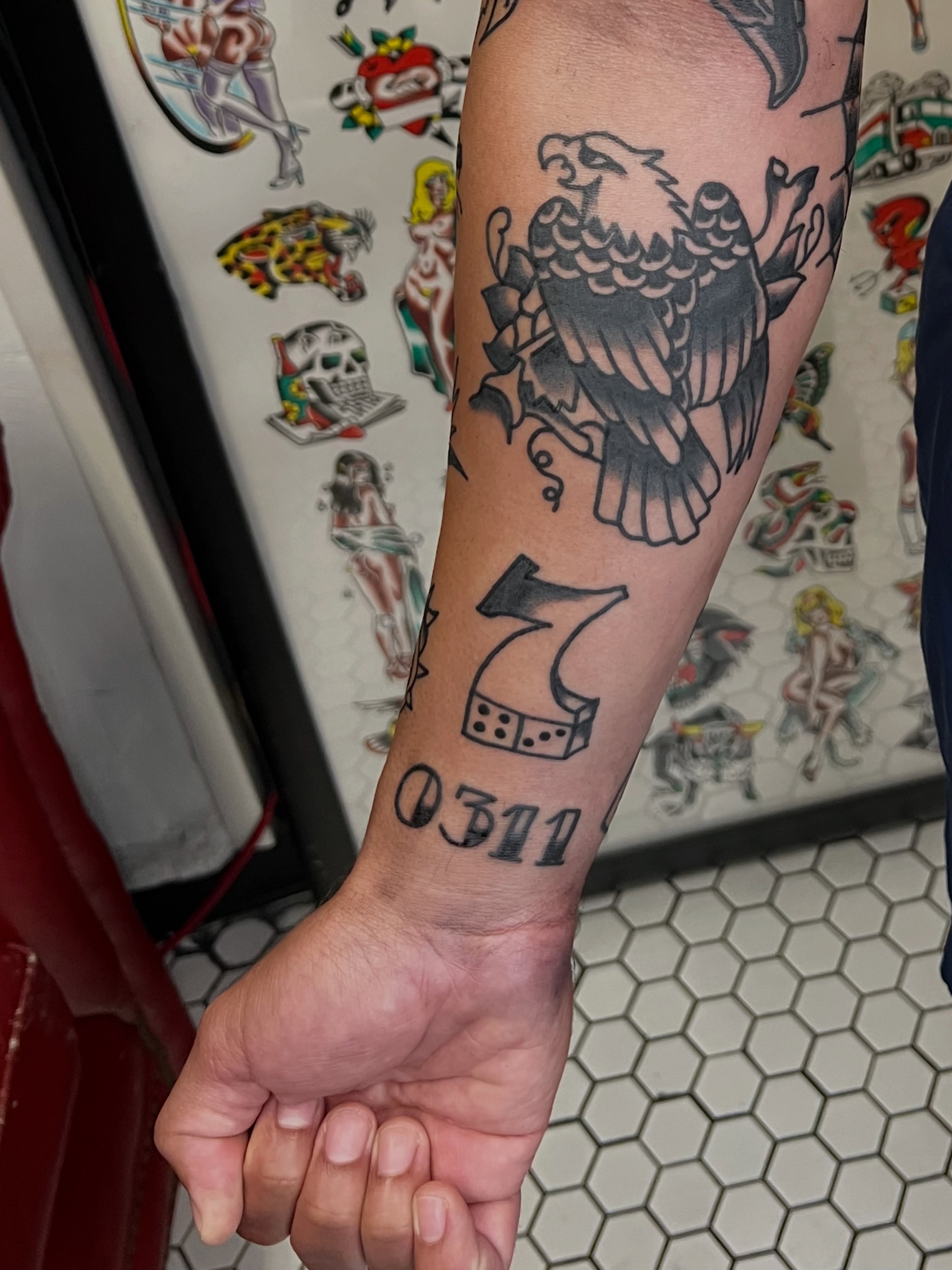 Eagle and dice American traditional tattoo on the forearm by Nestor Zelaya
