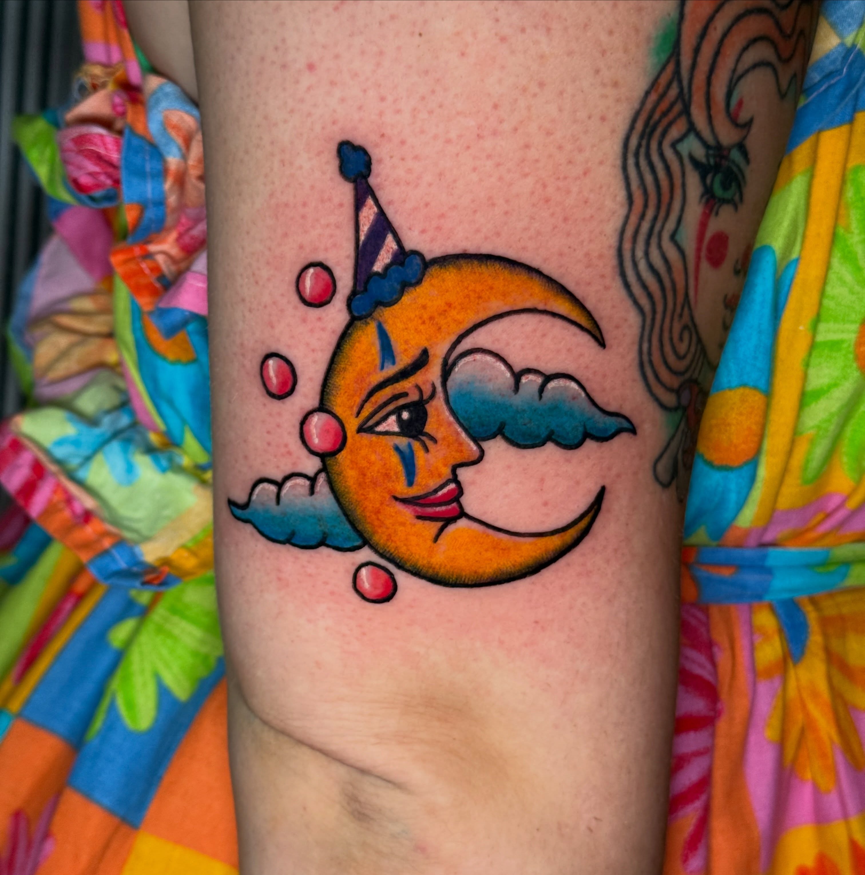 Moon with clown hat new school tattoo on the forearm by CAT