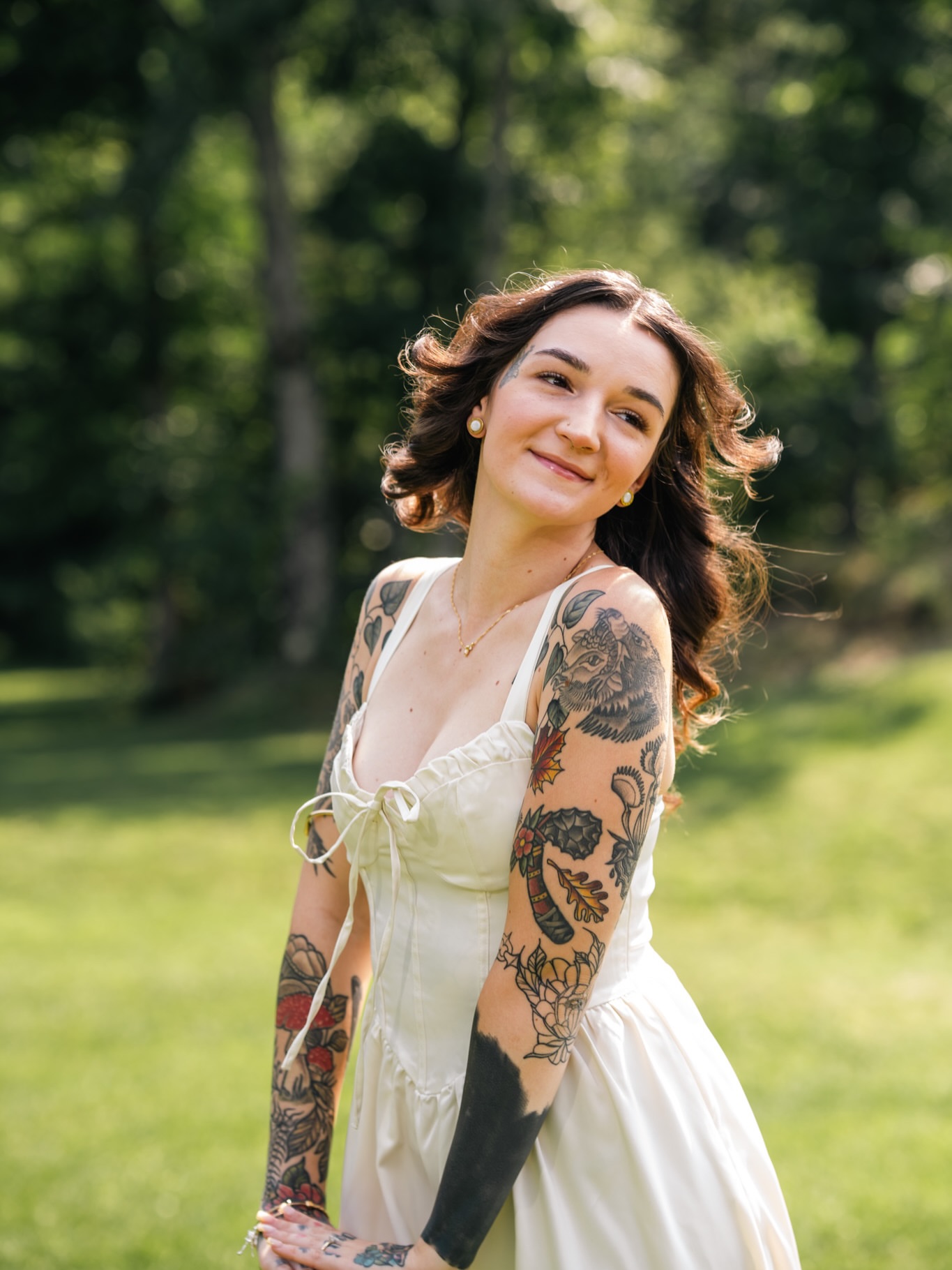 Floral and bird American traditional tattoo on the upper arm by Lyndze Masters