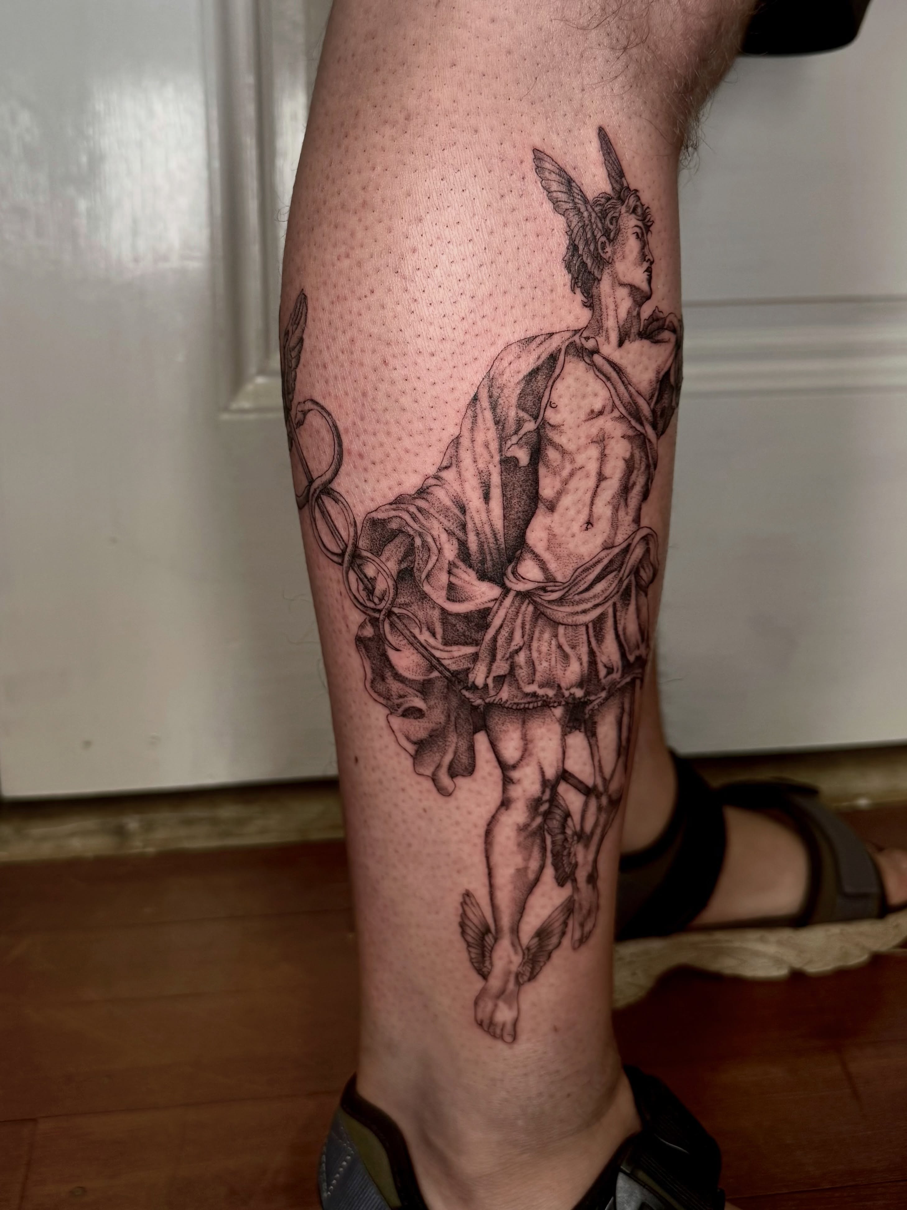 Angel with sword dotwork tattoo on the calf by Ian Saner