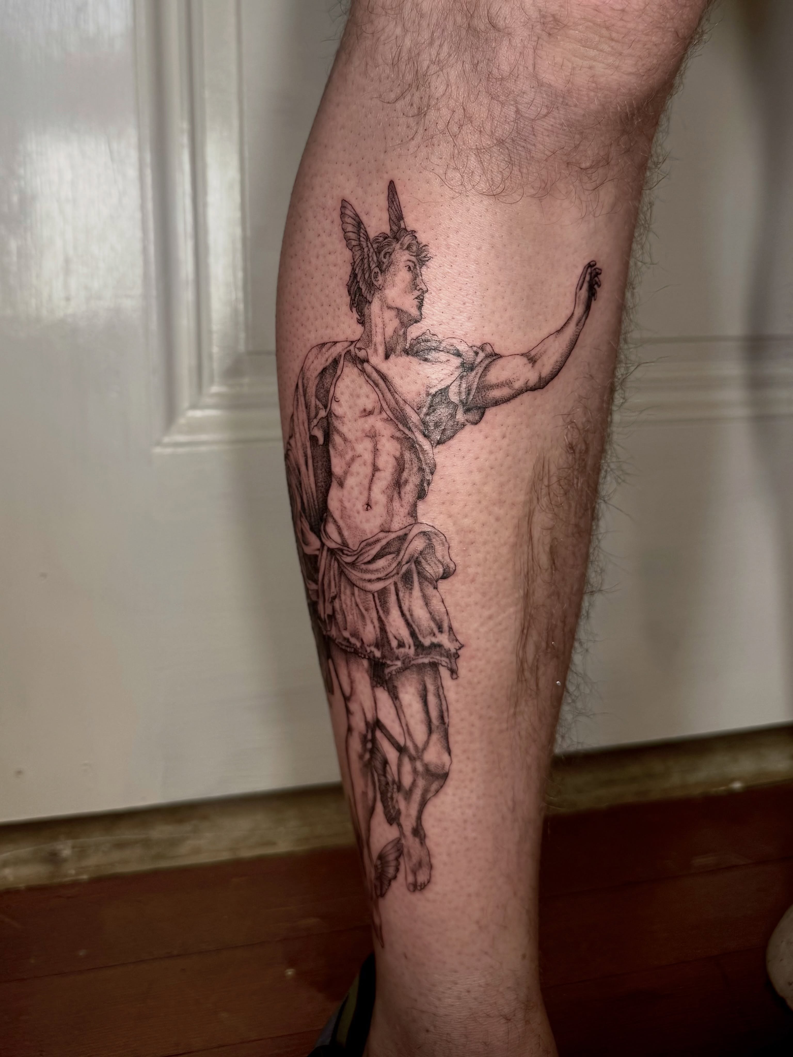 Mythical warrior realism tattoo on the calf by Ian Saner