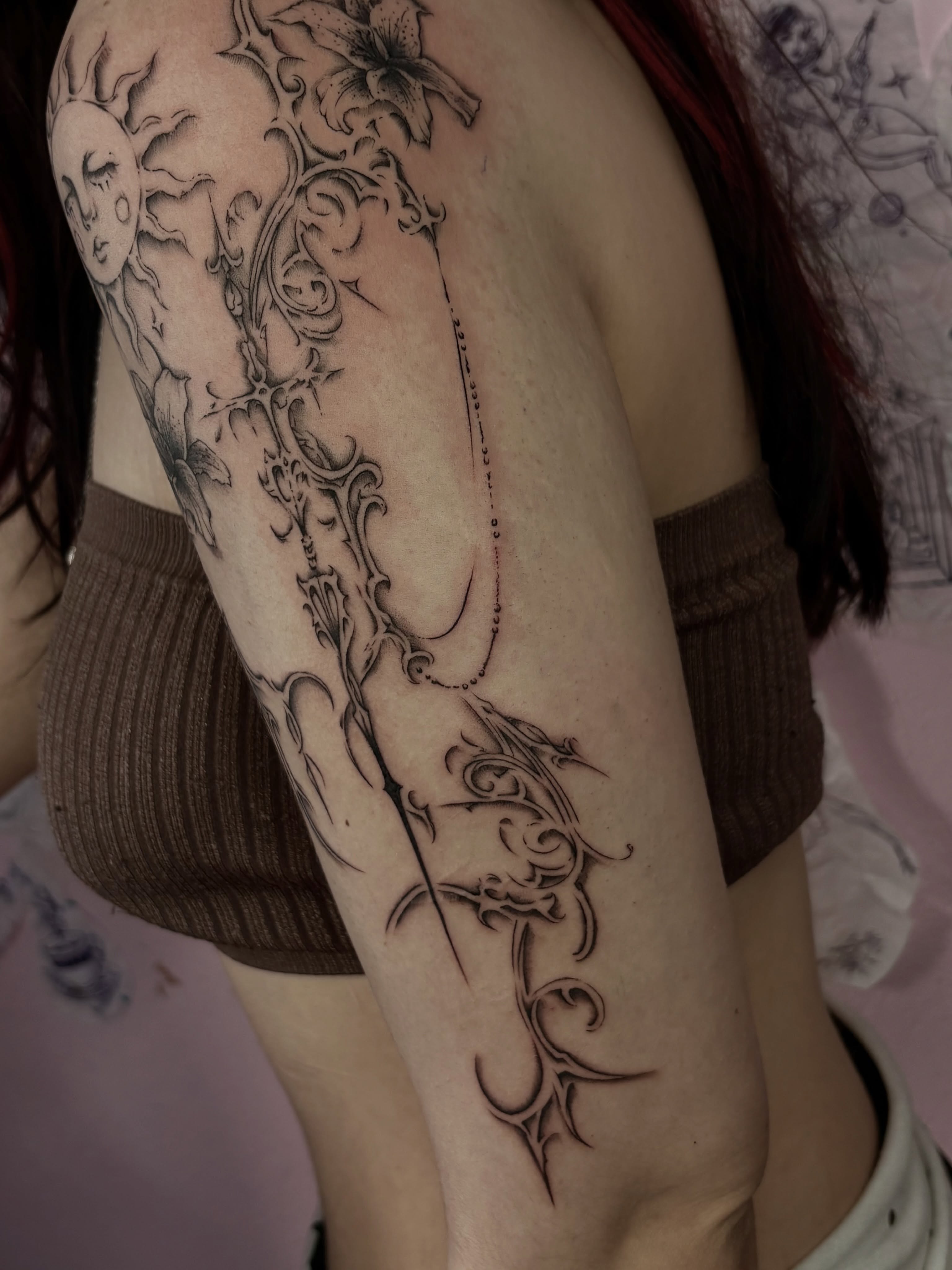 Floral and celestial motifs tribal tattoo on the upper arm by Silvia :)