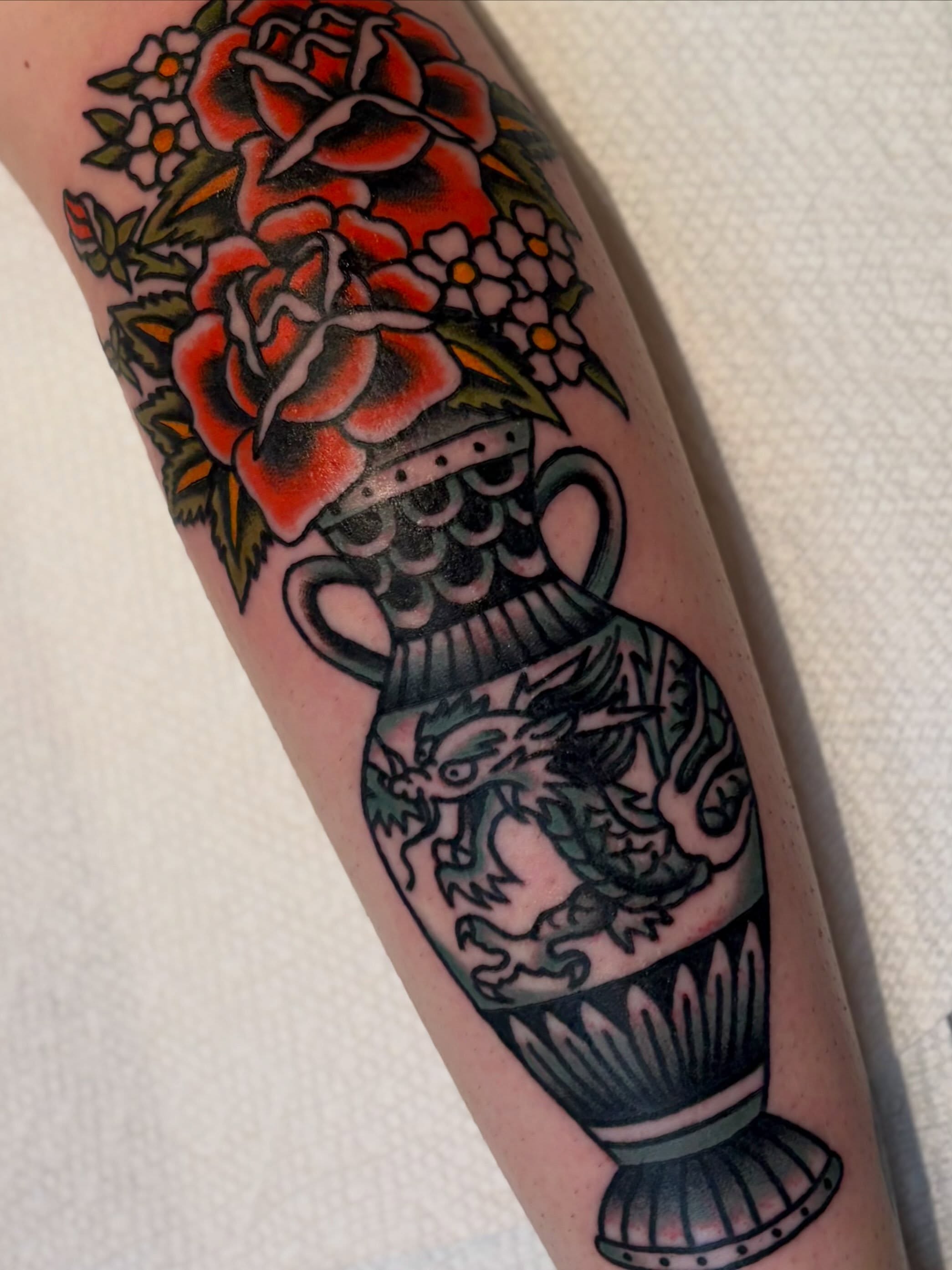 Vase with dragon American traditional tattoo on the forearm by Tia Cave