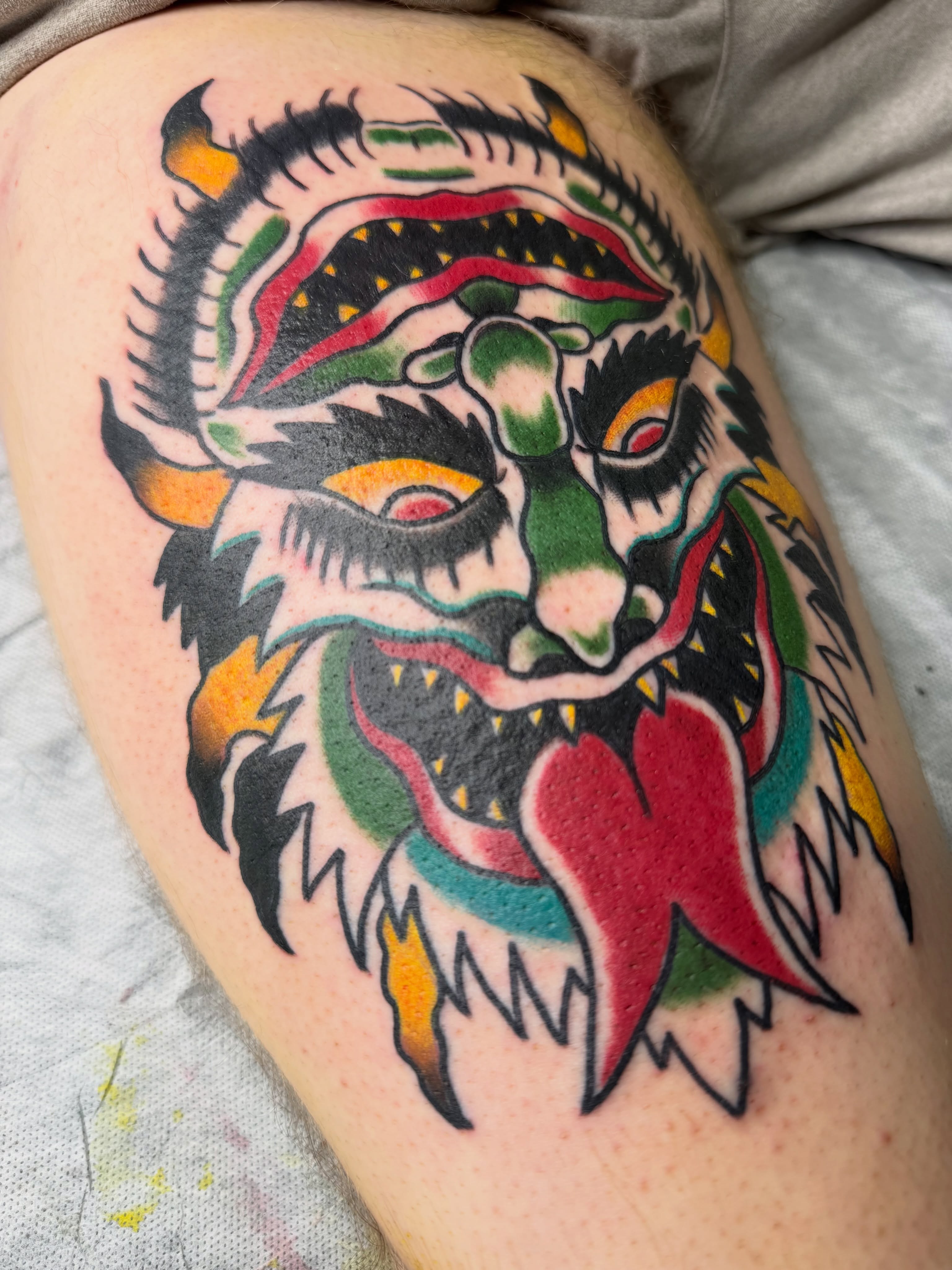 Demon head American traditional tattoo on the thigh by Eric James, Columbus, Ohio