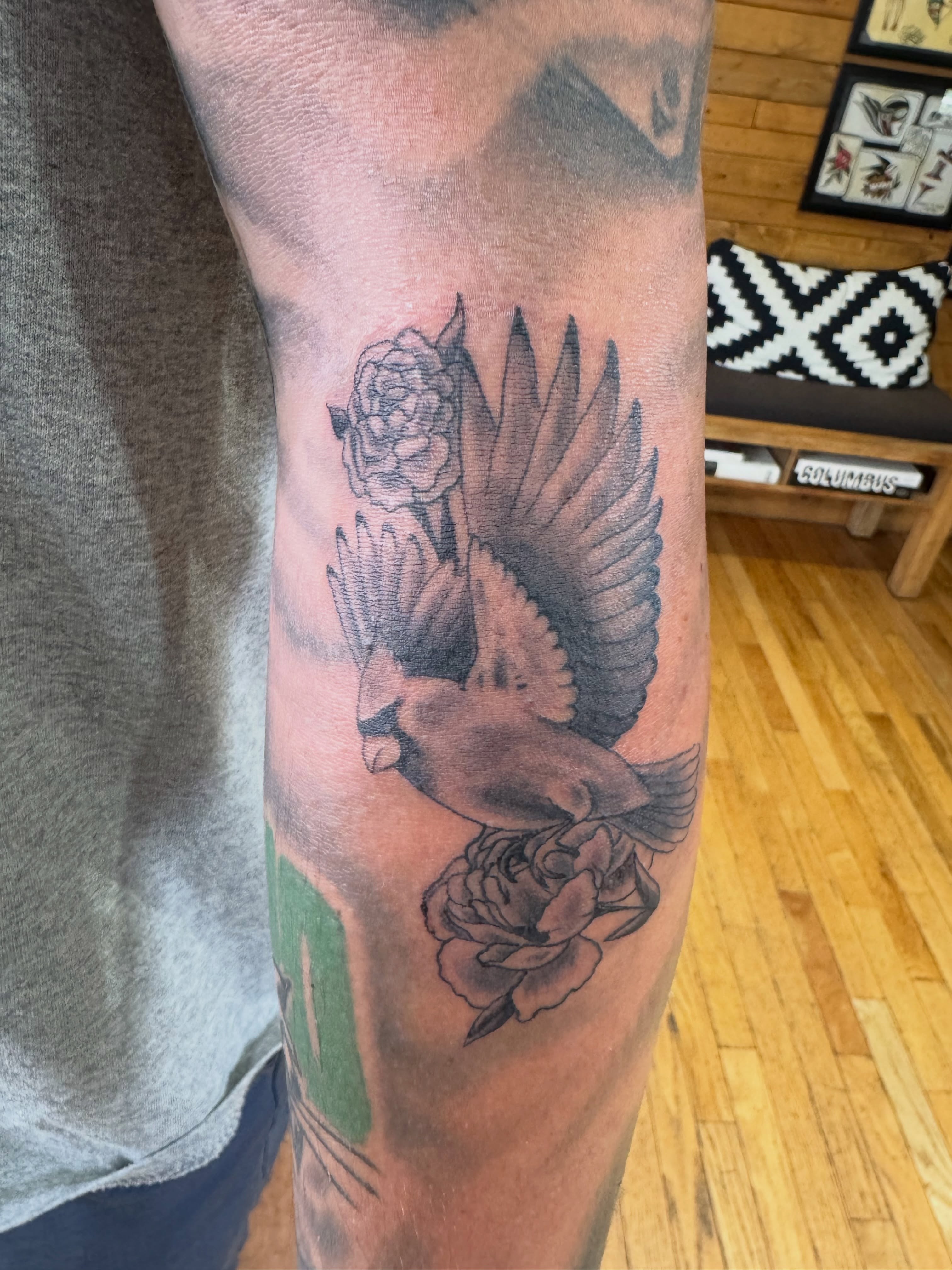 Bird and flower black and grey tattoo on the forearm by Eric James, Columbus, Ohio