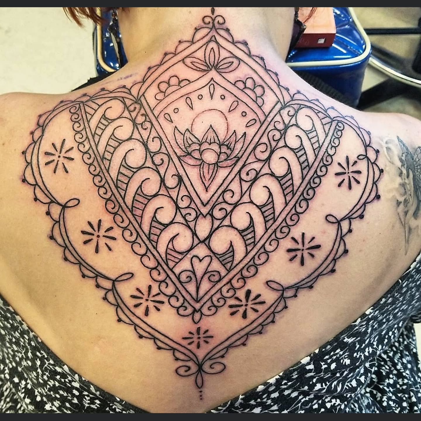 Mandala ornamental tattoo on the back by Shane Watkins