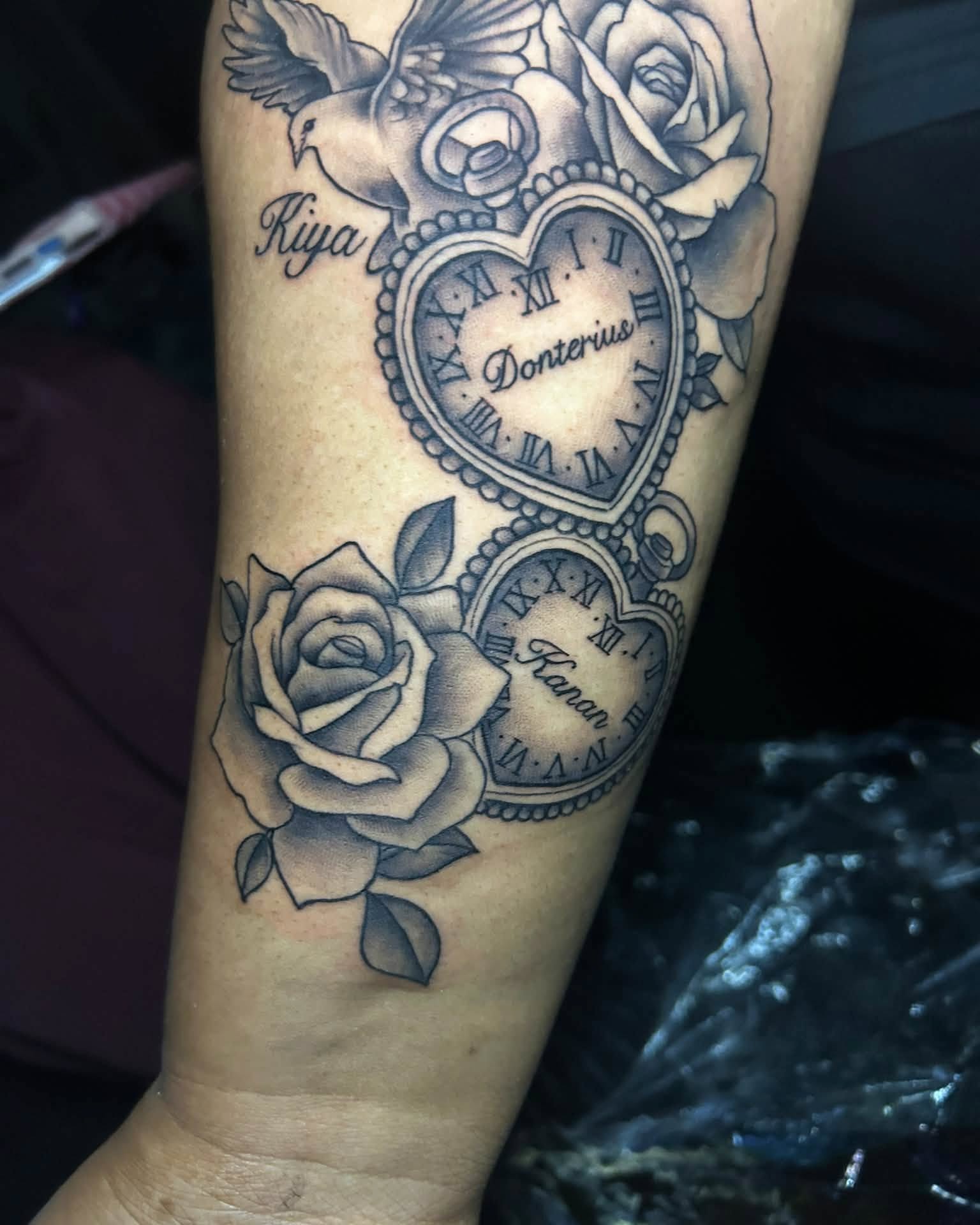 Heart clock and roses black and grey tattoo on the forearm by Ferlandis Fitch, Long Beach, California