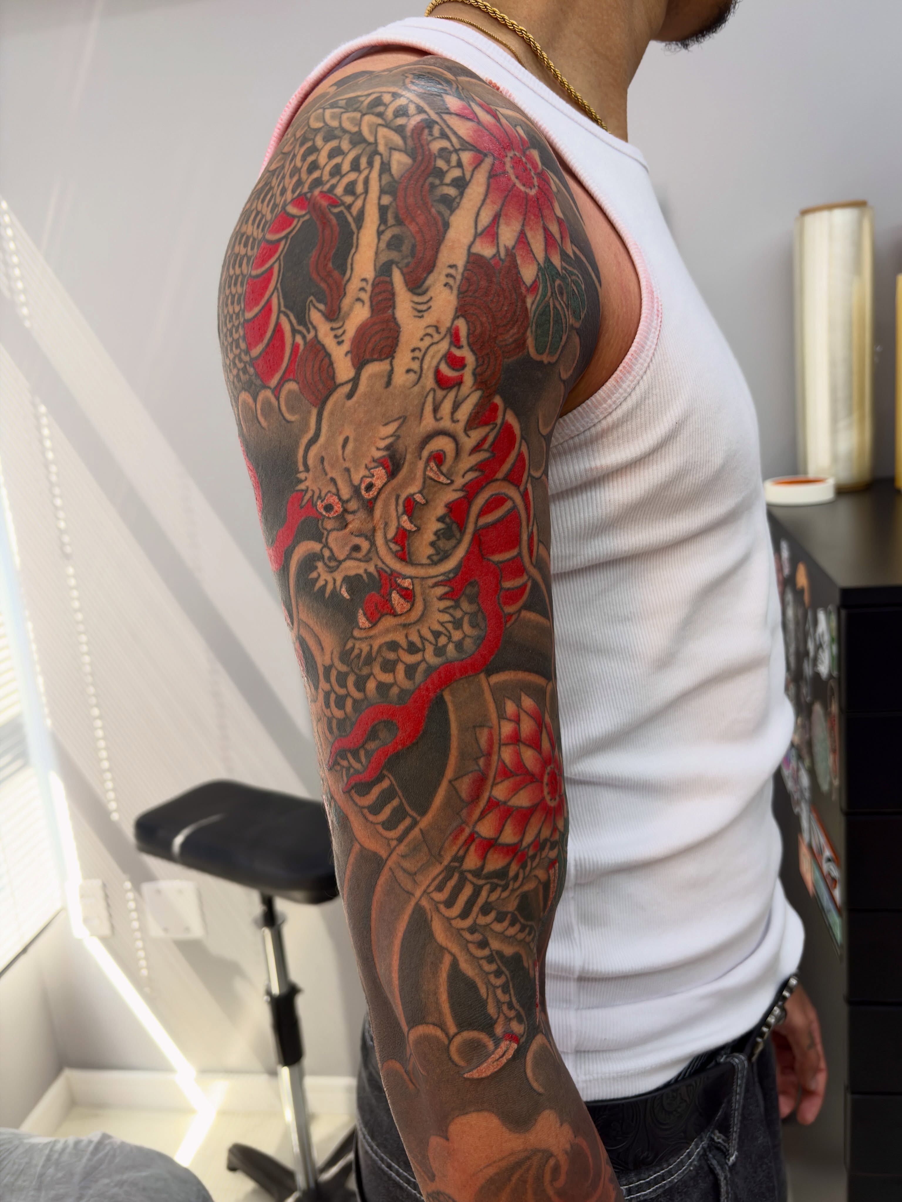 Dragon and lotus japanese irezumi tattoo on the upper arm by Lucas Naganuma