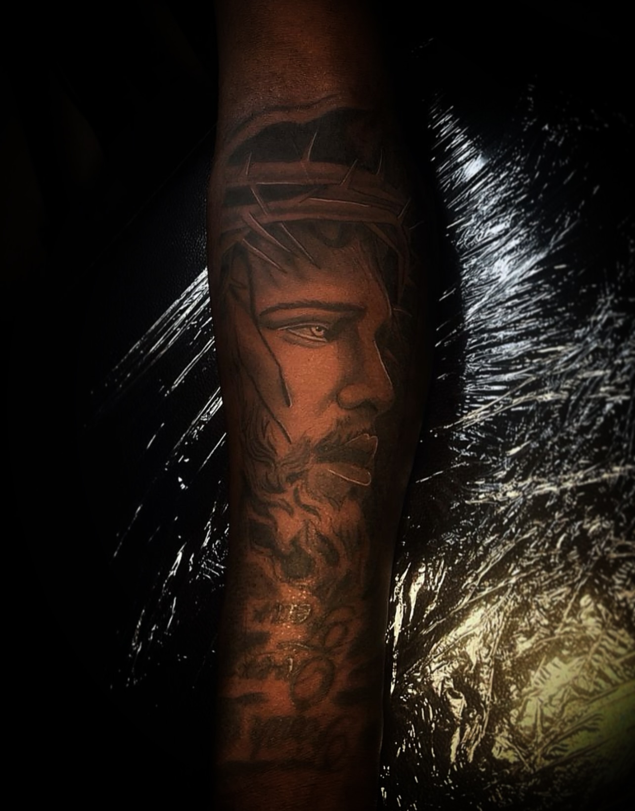 Religious figure realism tattoo on the forearm by @tattsbyleek