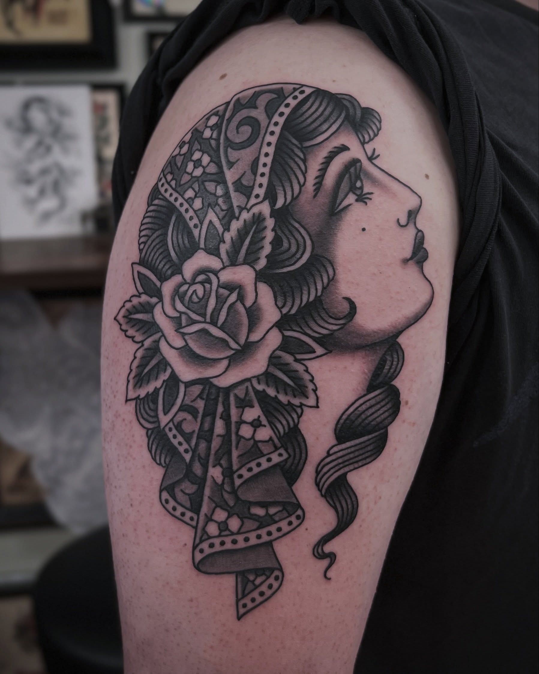 Woman with rose American traditional tattoo on the shoulder by Brian Visser