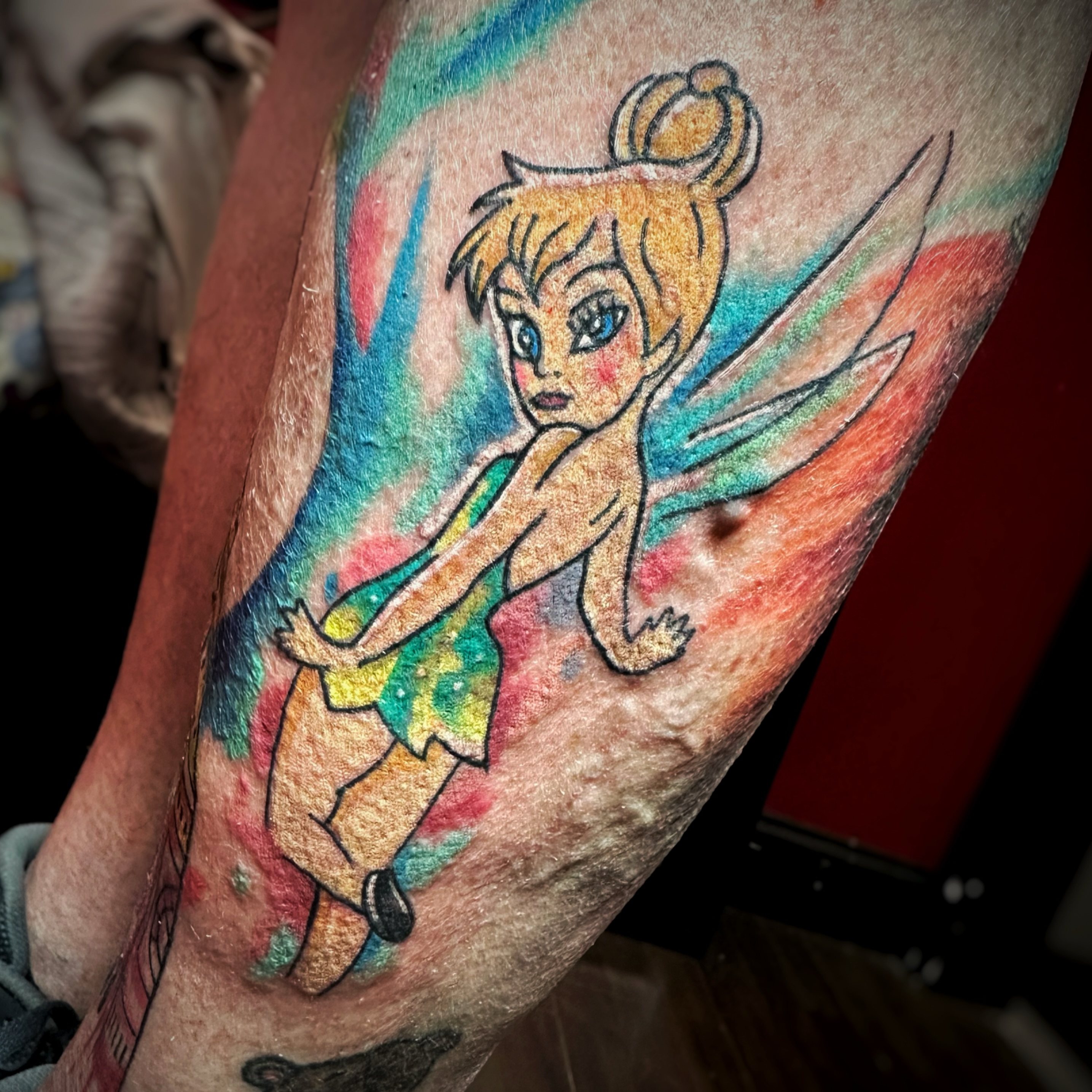 Tinker Bell watercolor tattoo on the forearm by Anthony Guido