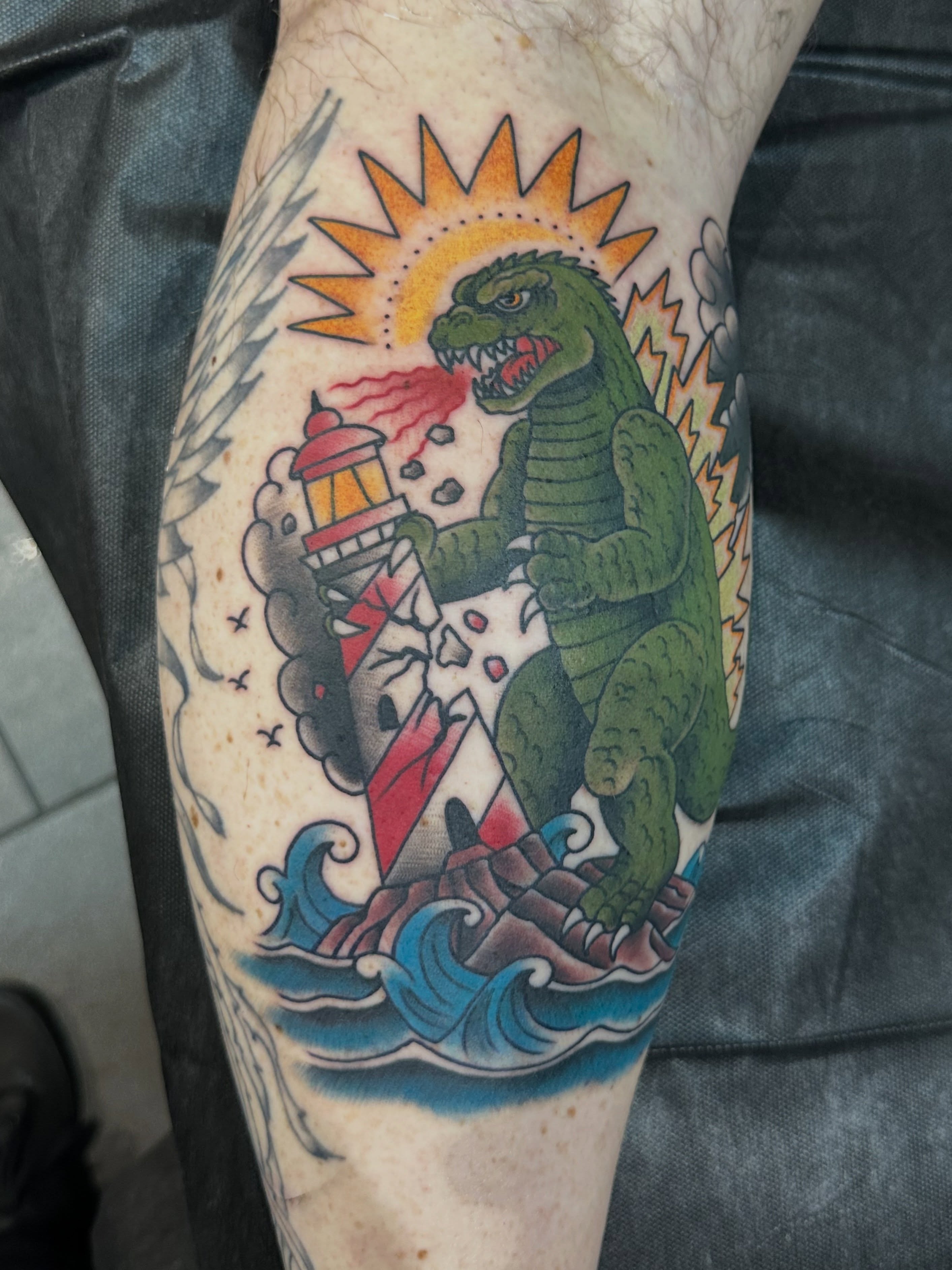 Godzilla American traditional tattoo on the forearm by Walk-in American Traditional Tattoos Las
