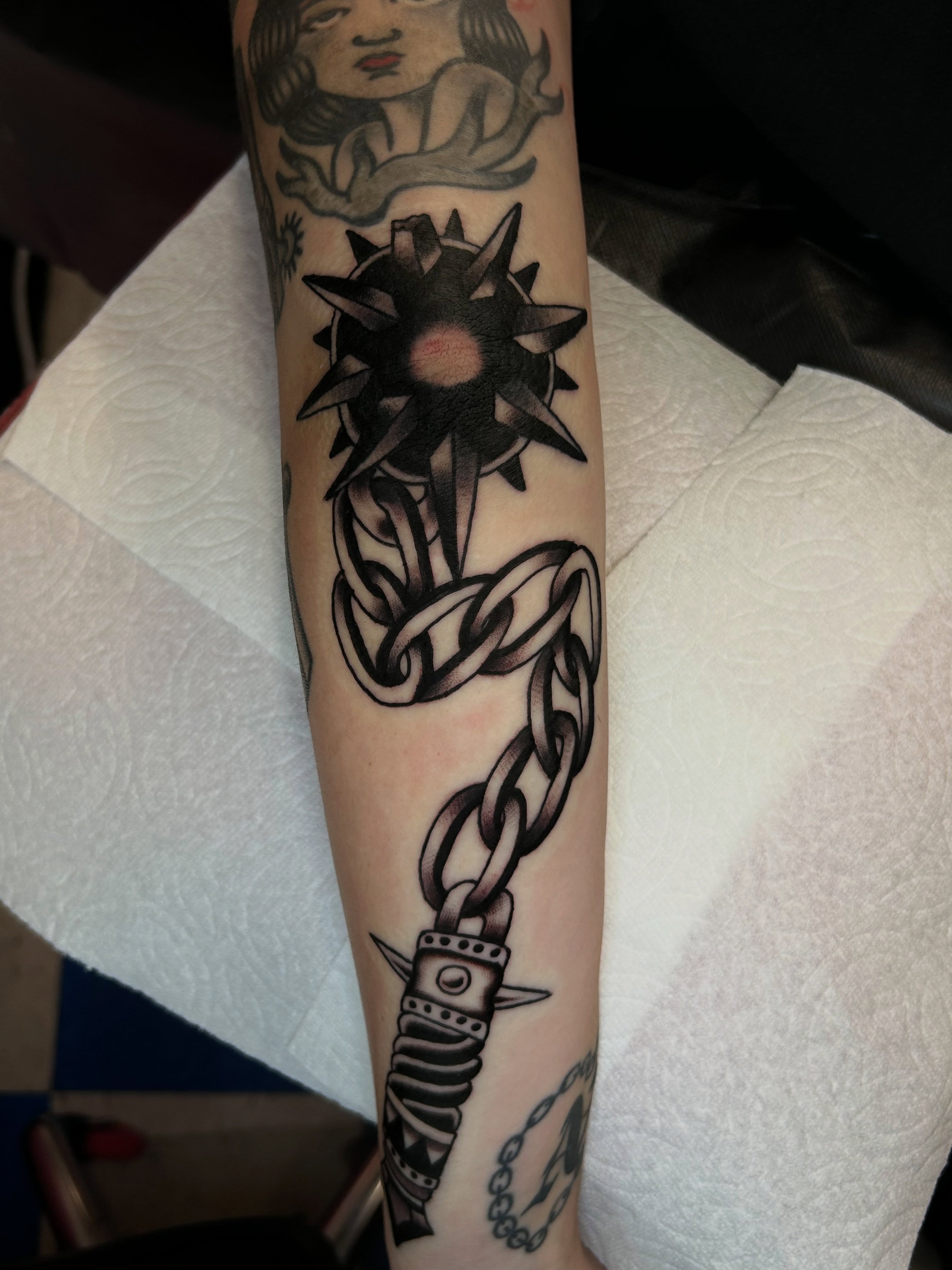 Chain and sun black and grey tattoo on the forearm by β π€ππ©π¦π©π’π β± β