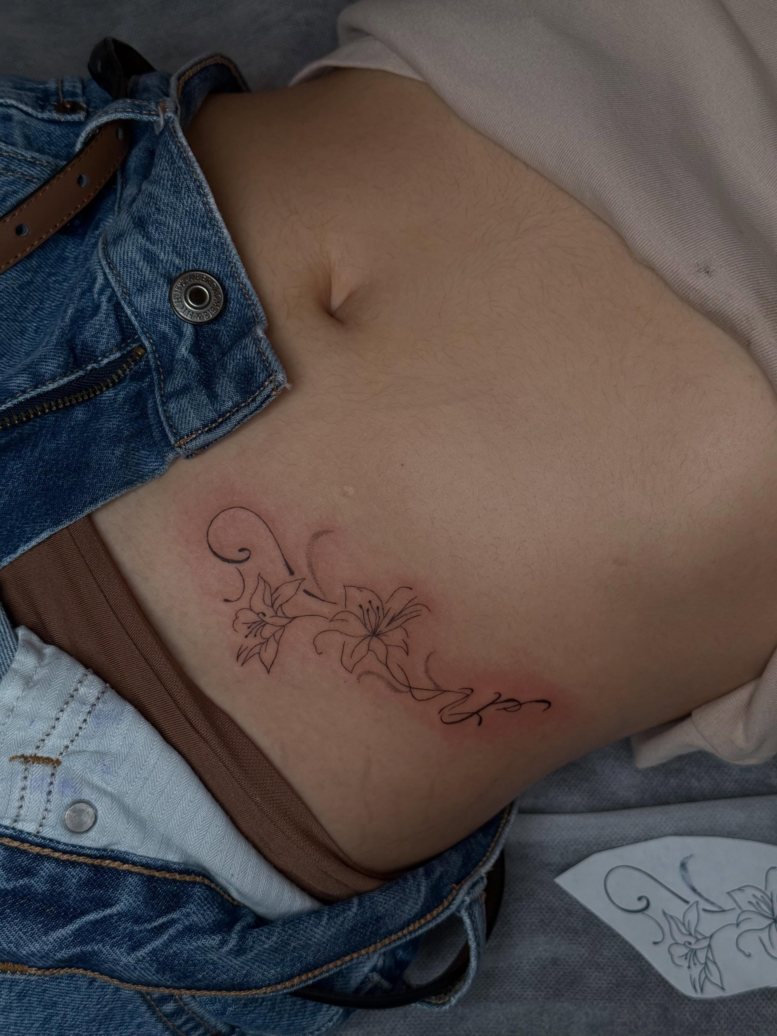 Flowers fine line tattoo on the ribs by TATTOO & PIERCING ARTIST ₊˚⊹ ᰔ