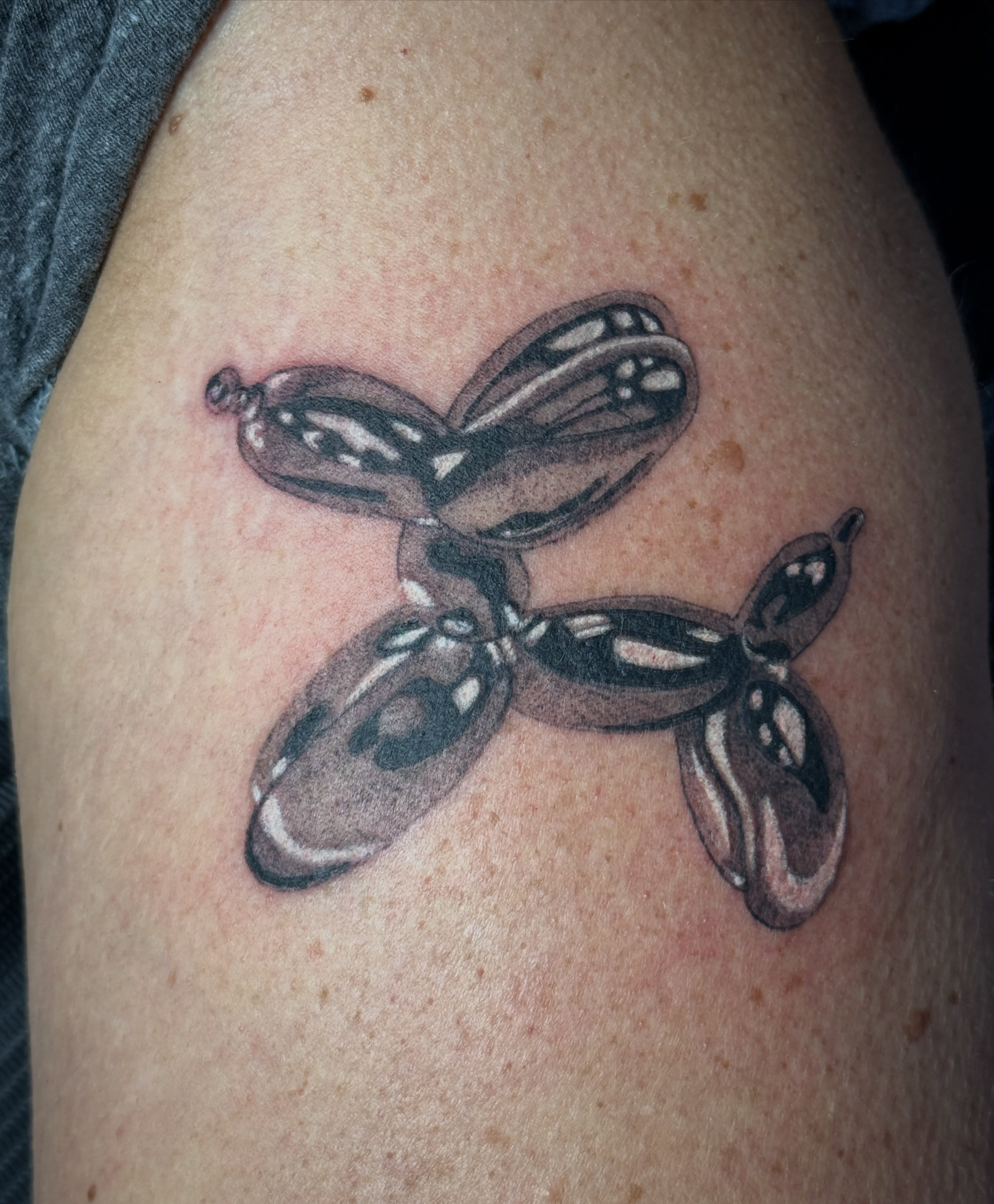 Balloon animal black and grey tattoo on the thigh by Bronzino Ink - Karen, Asheville, North Carolina