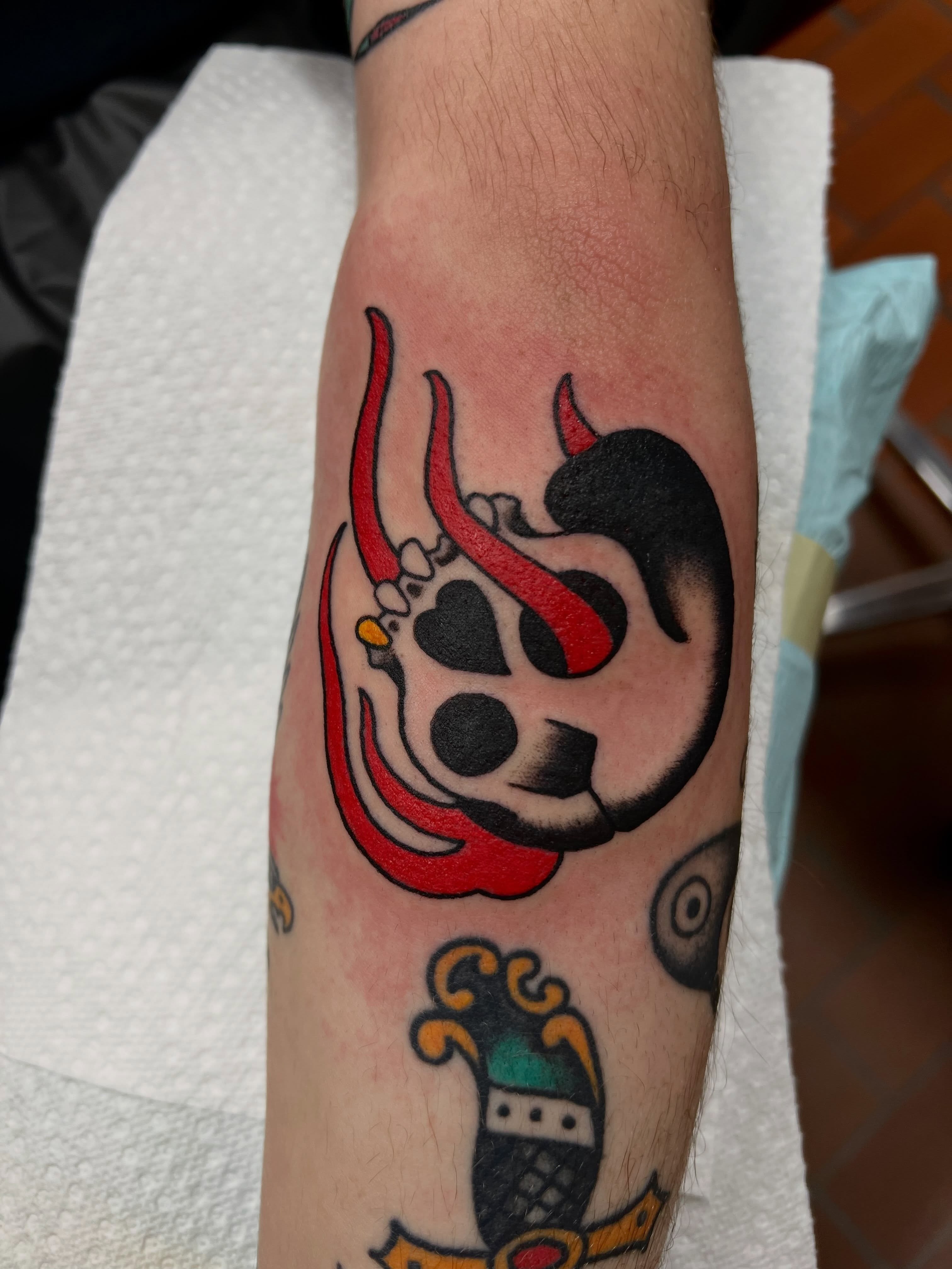 Heart with horns American traditional tattoo on the forearm by Brandon McDaniel Iowa Tattoo Artist