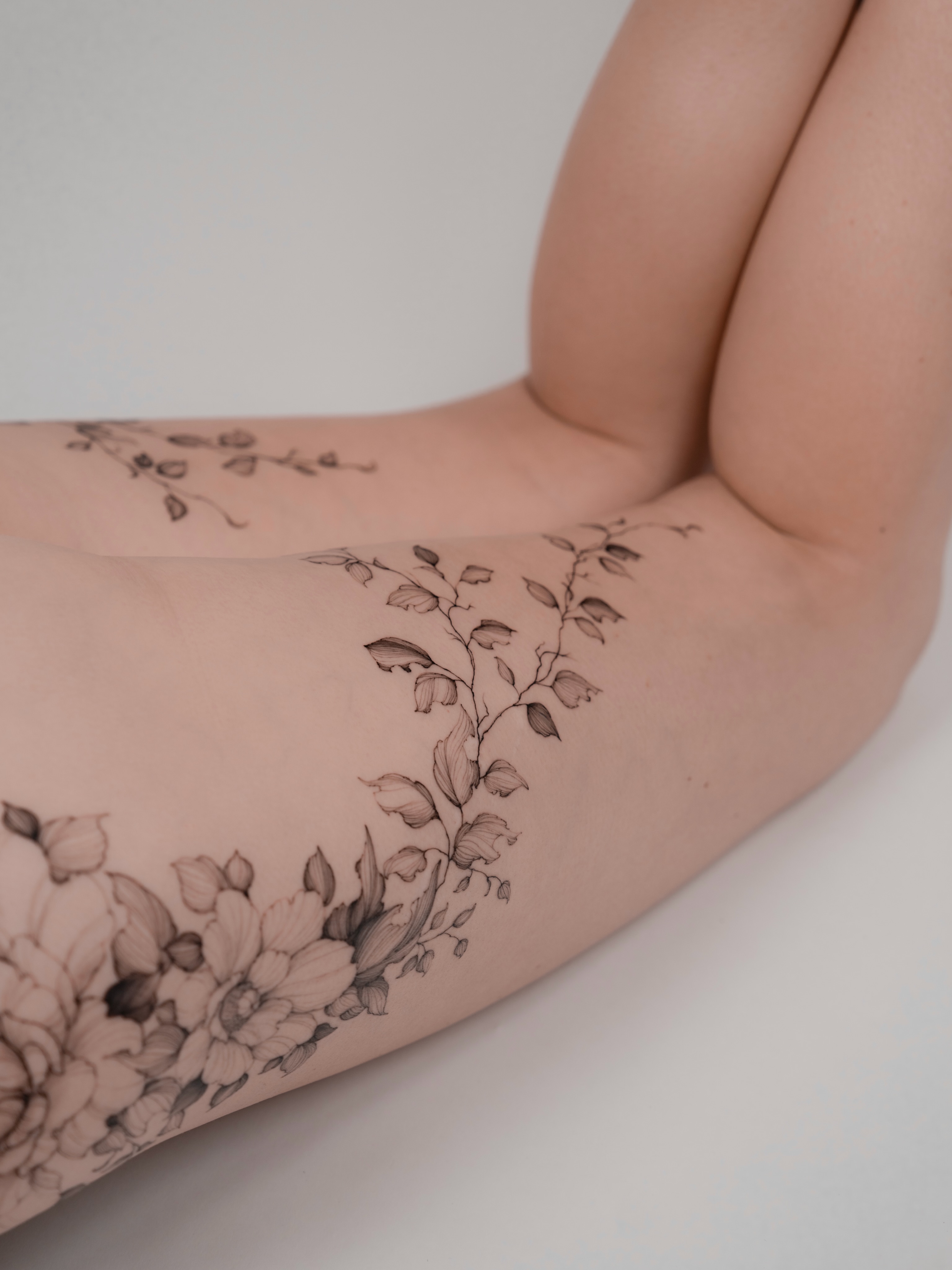 Floral vine black and grey tattoo on the forearm by Marek