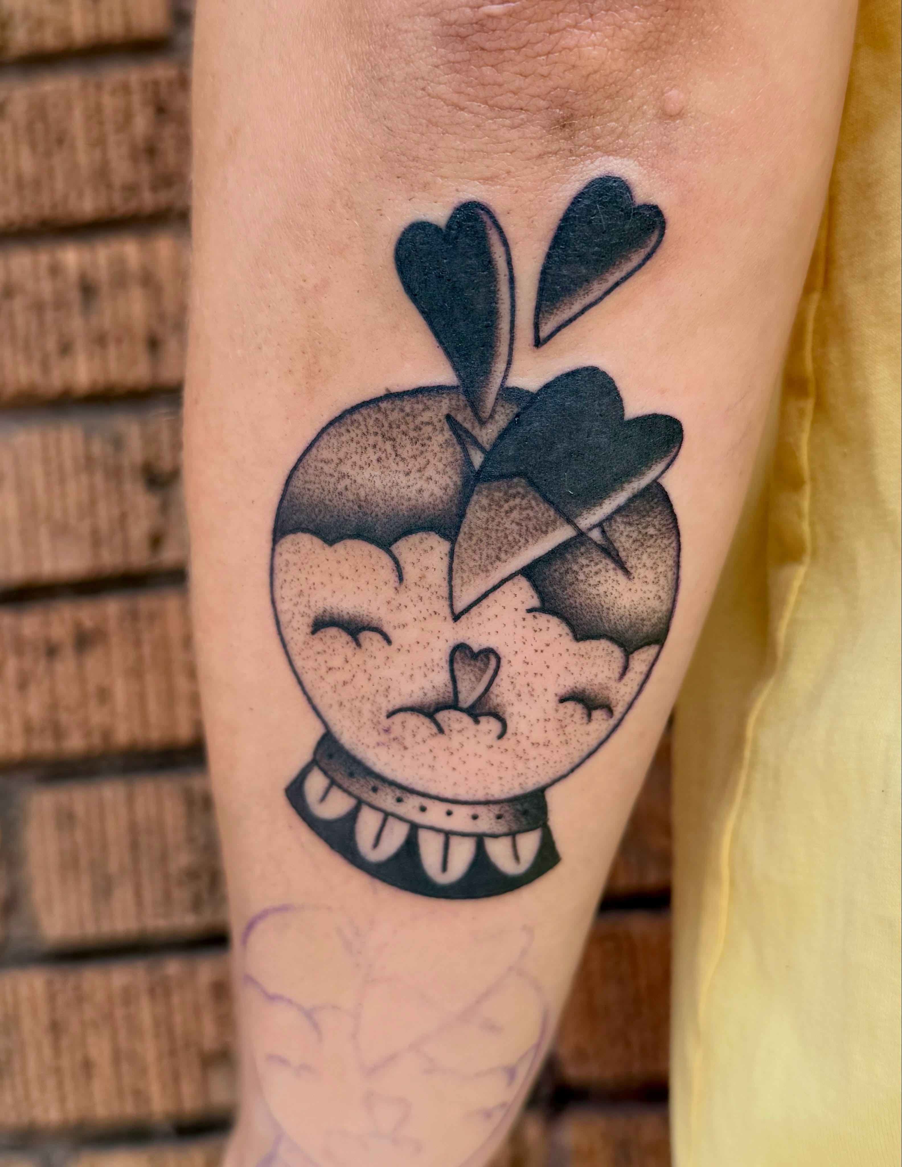 Apple with heart dotwork tattoo on the forearm by Sophie McTear