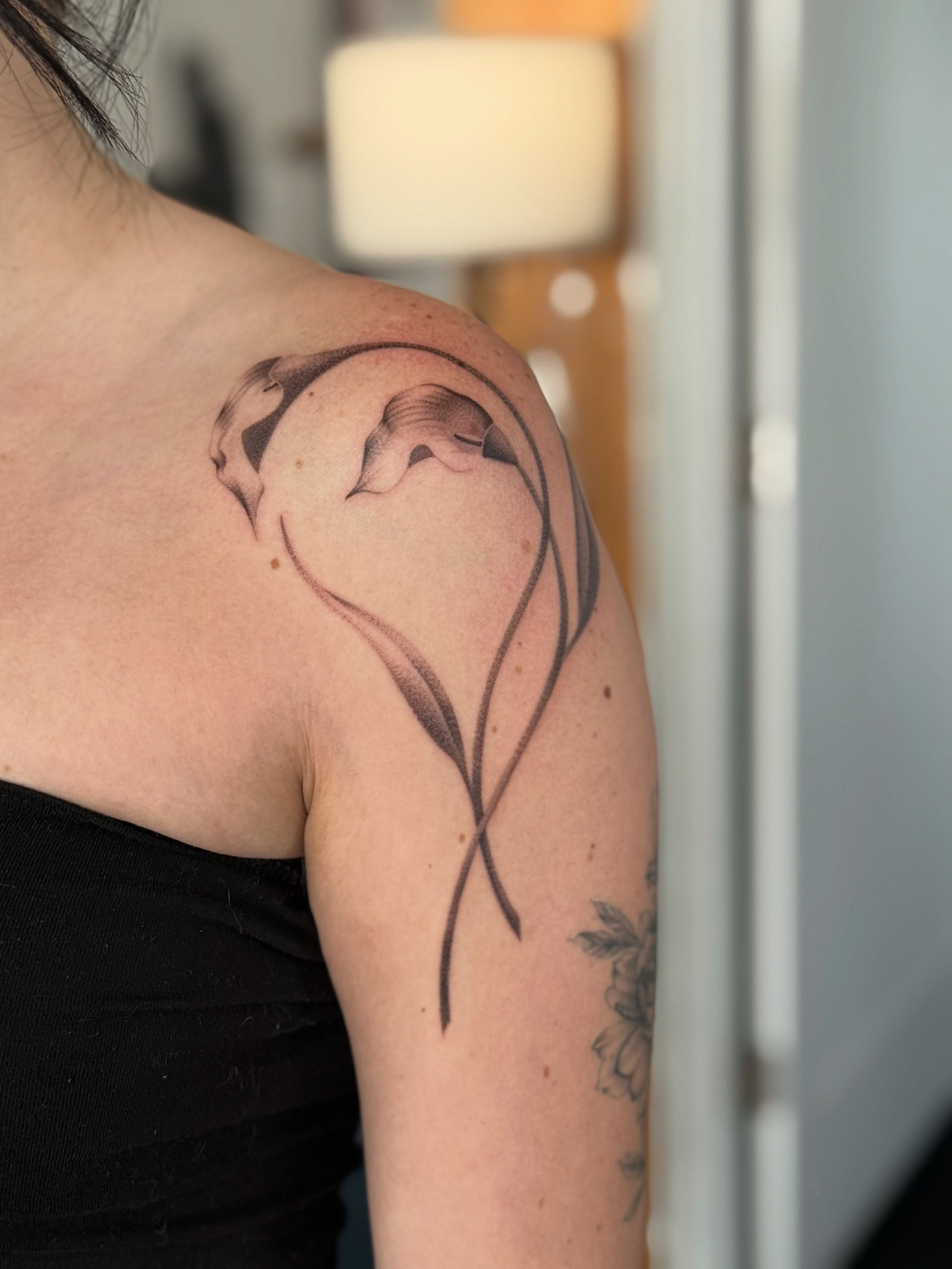 Calla lily black and grey tattoo on the shoulder by Hayley Jude