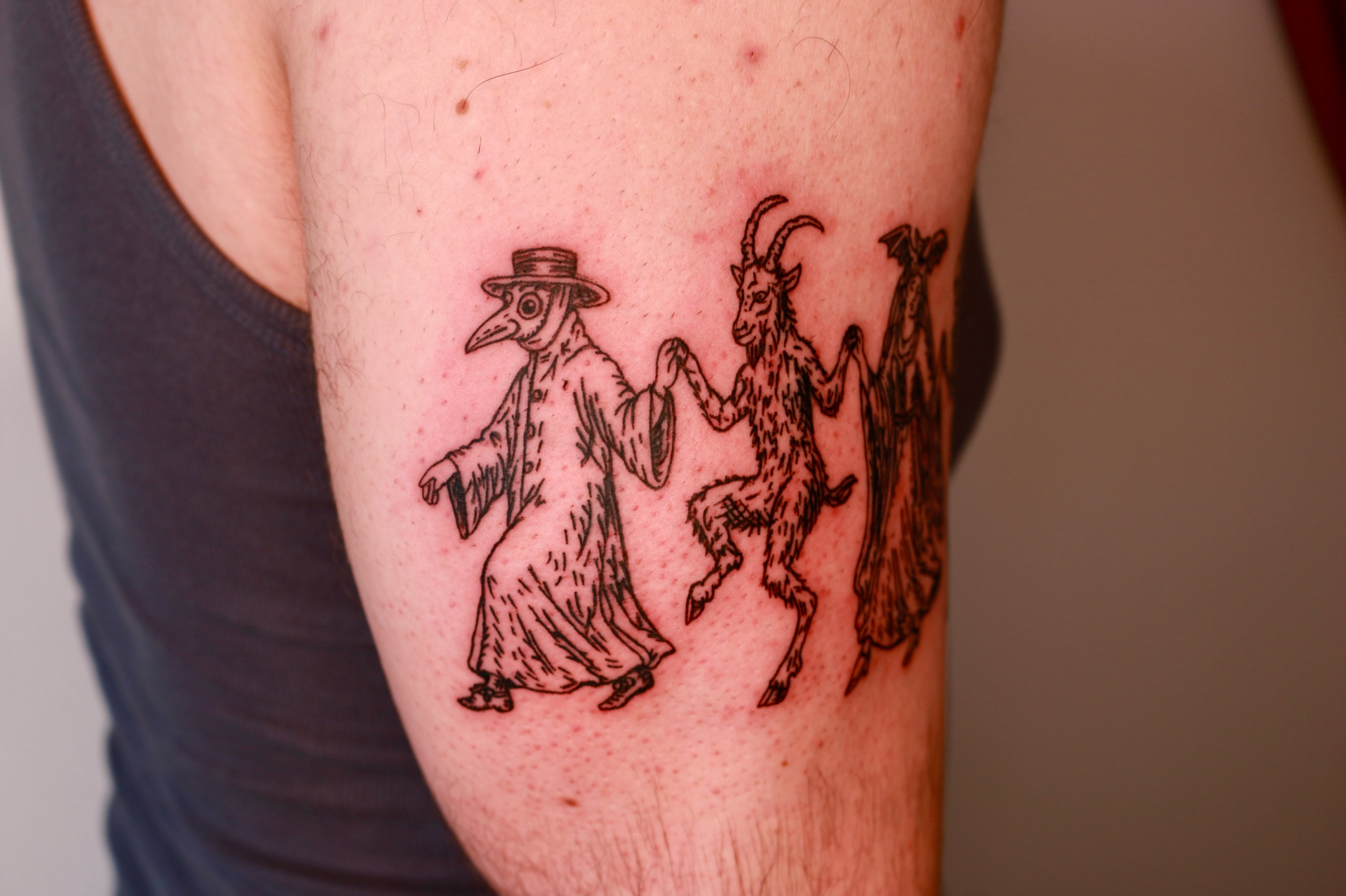 Plague doctor and goats black and grey tattoo on the forearm by Mike
