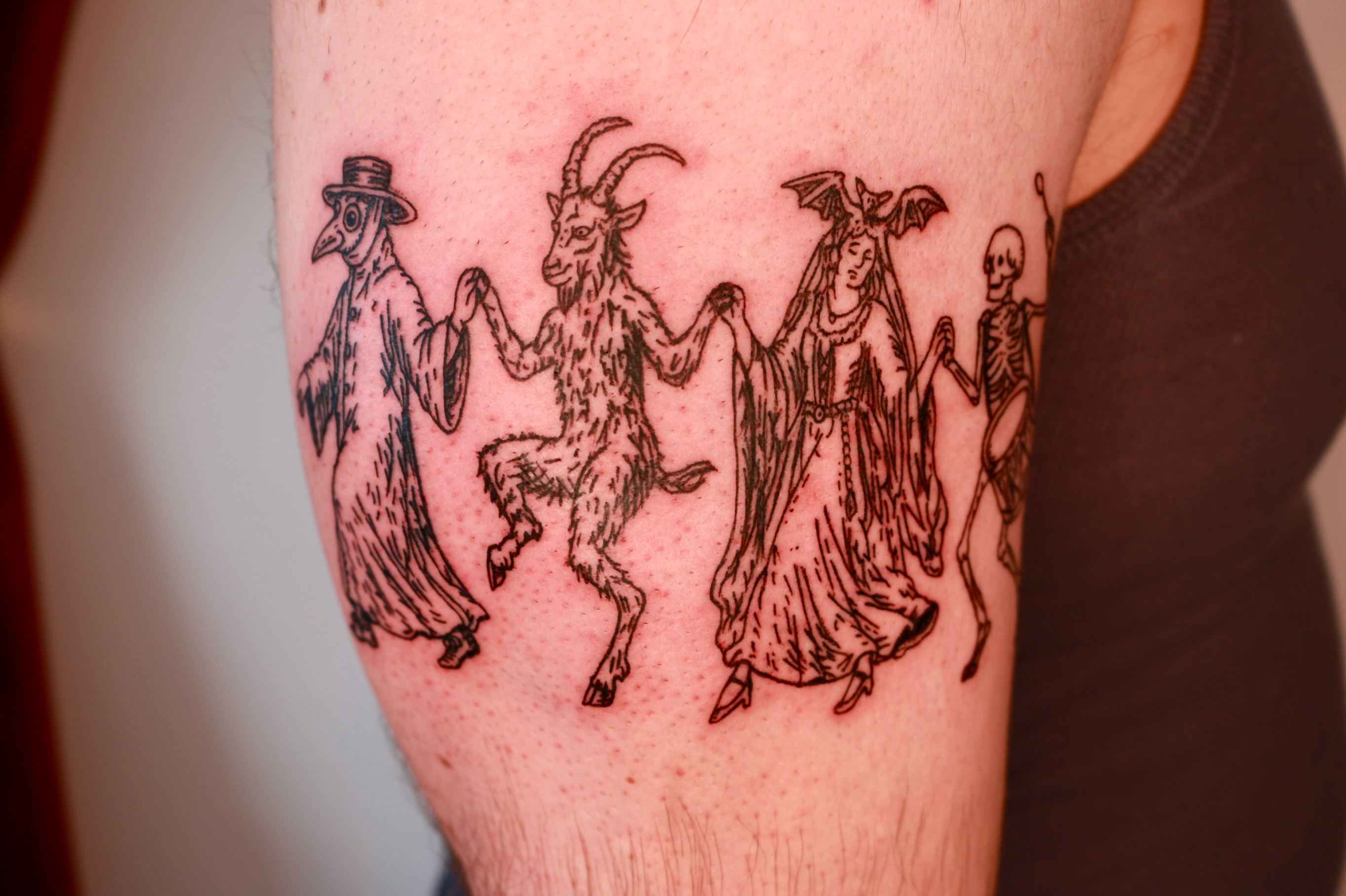 Gothic figures black and grey tattoo on the forearm by Mike