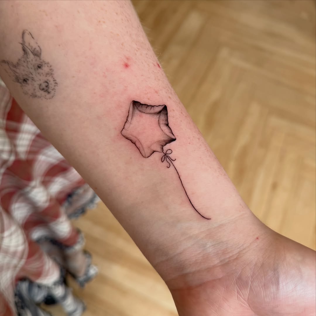 Balloon fine line tattoo on the forearm by Fine Line Tattoos
