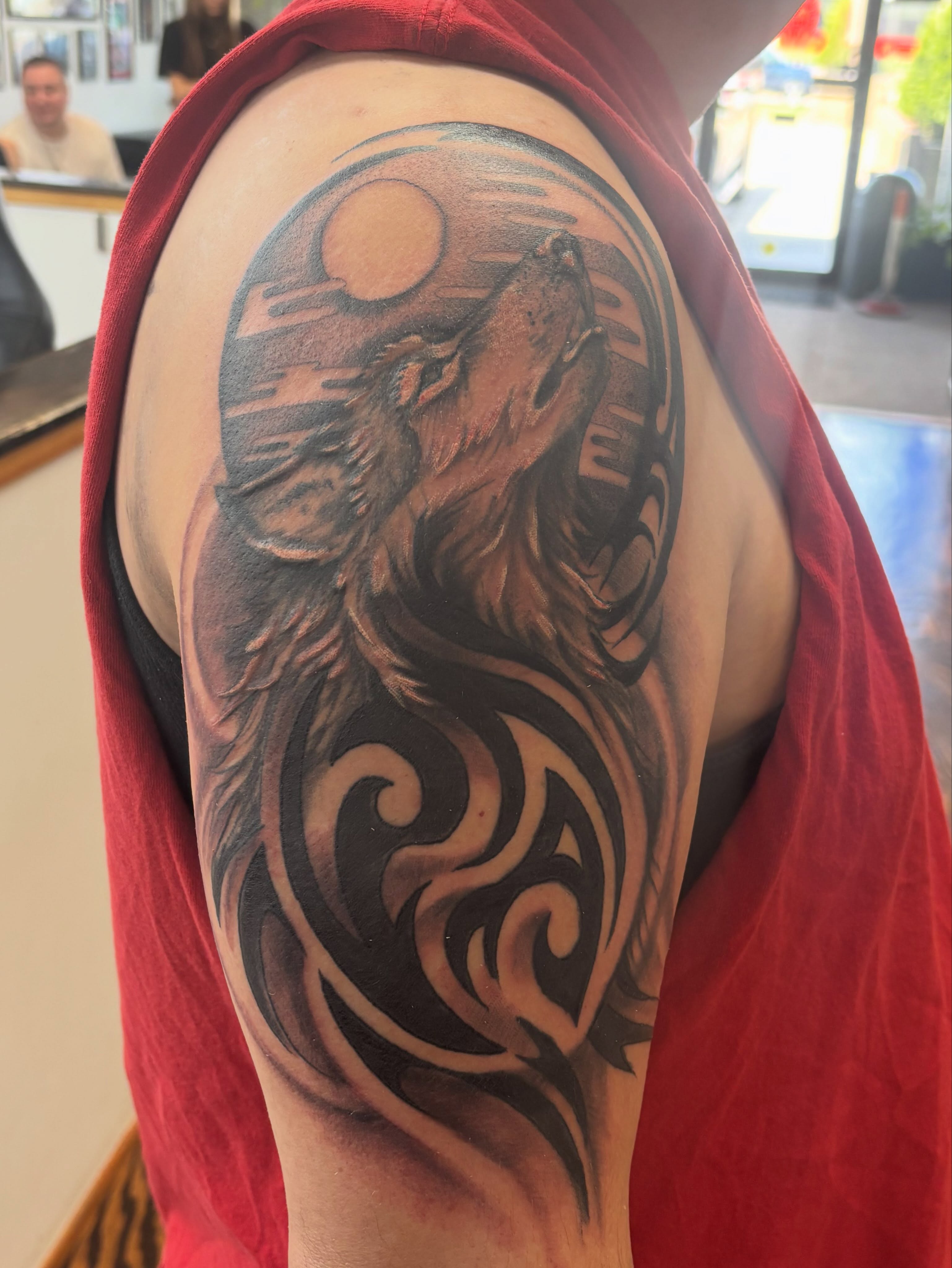Wolf howling tribal tattoo on the shoulder by Sam Hearnen, Lawrence, Kansas