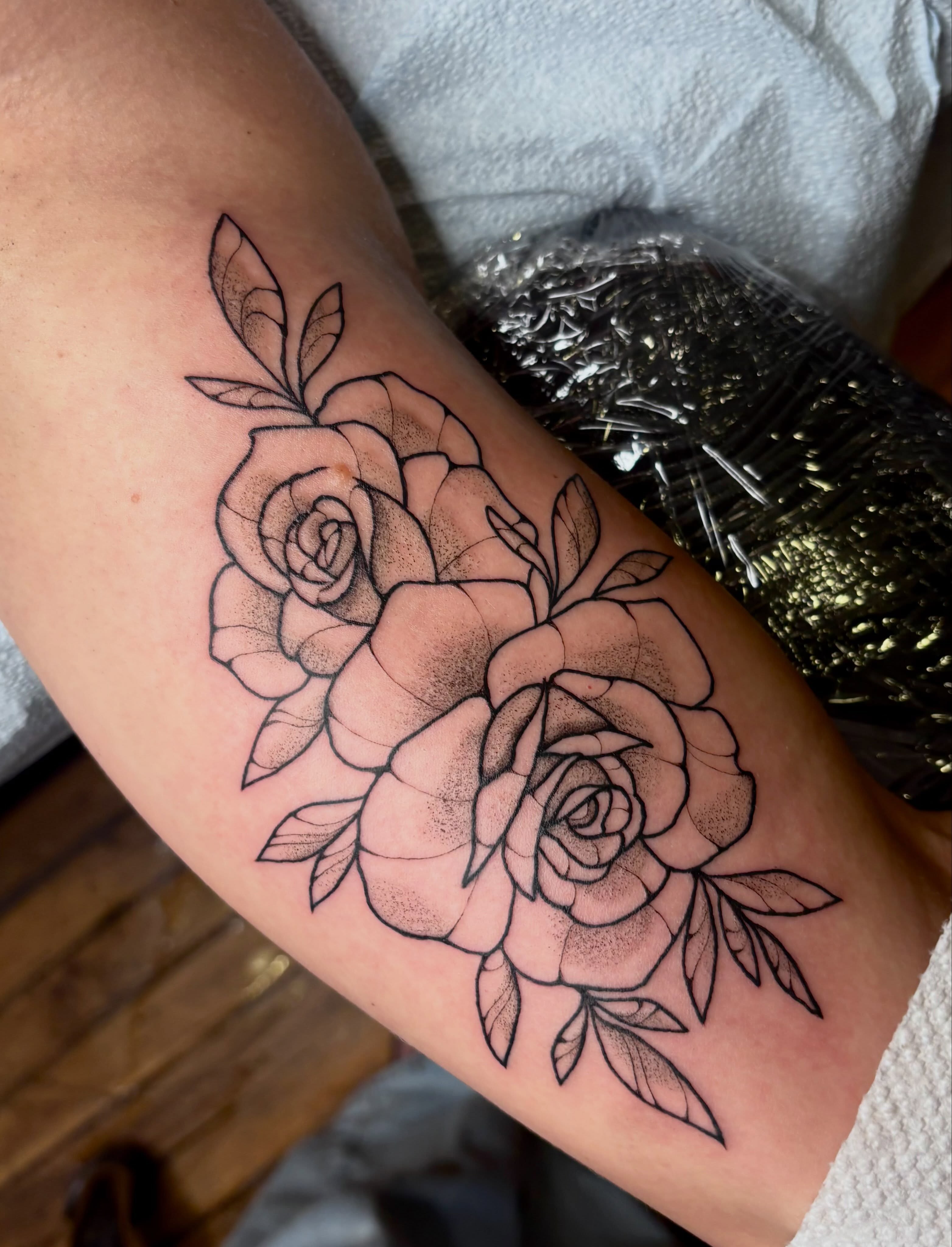 Roses dotwork tattoo on the forearm by Emmy Gallagher