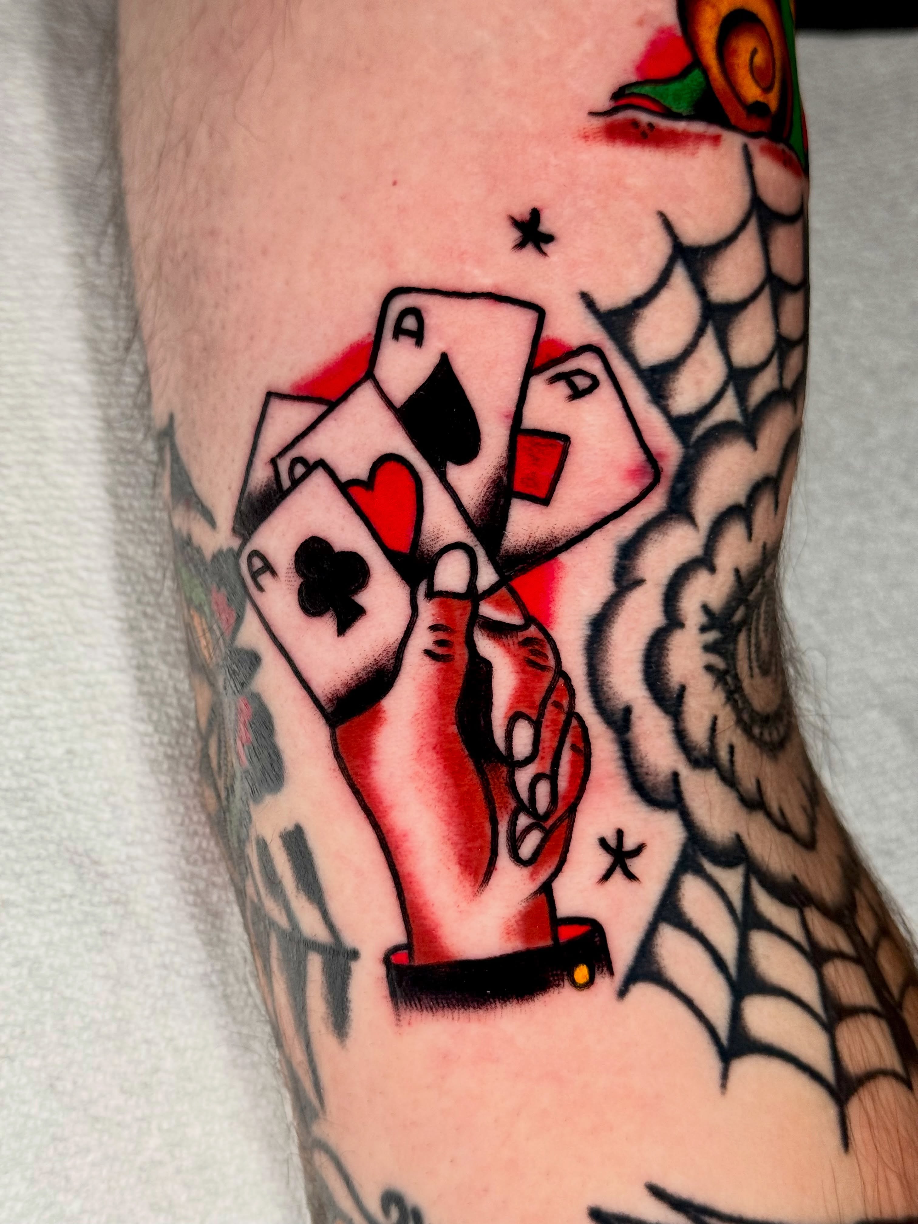 Playing cards American traditional tattoo on the forearm by Joe Bear Tattooer