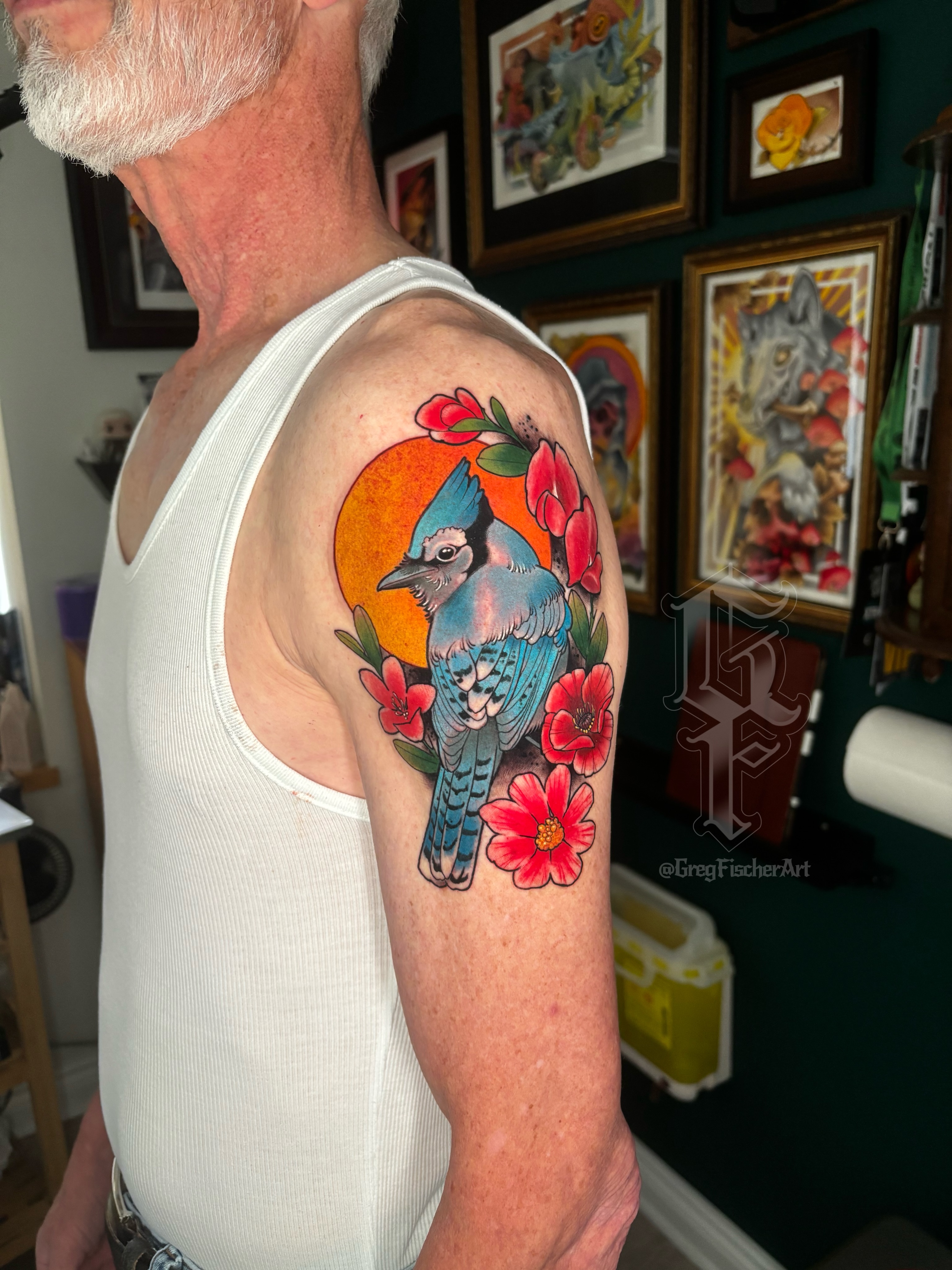 Blue jay and flowers American traditional tattoo on the shoulder by Greg Fischer
