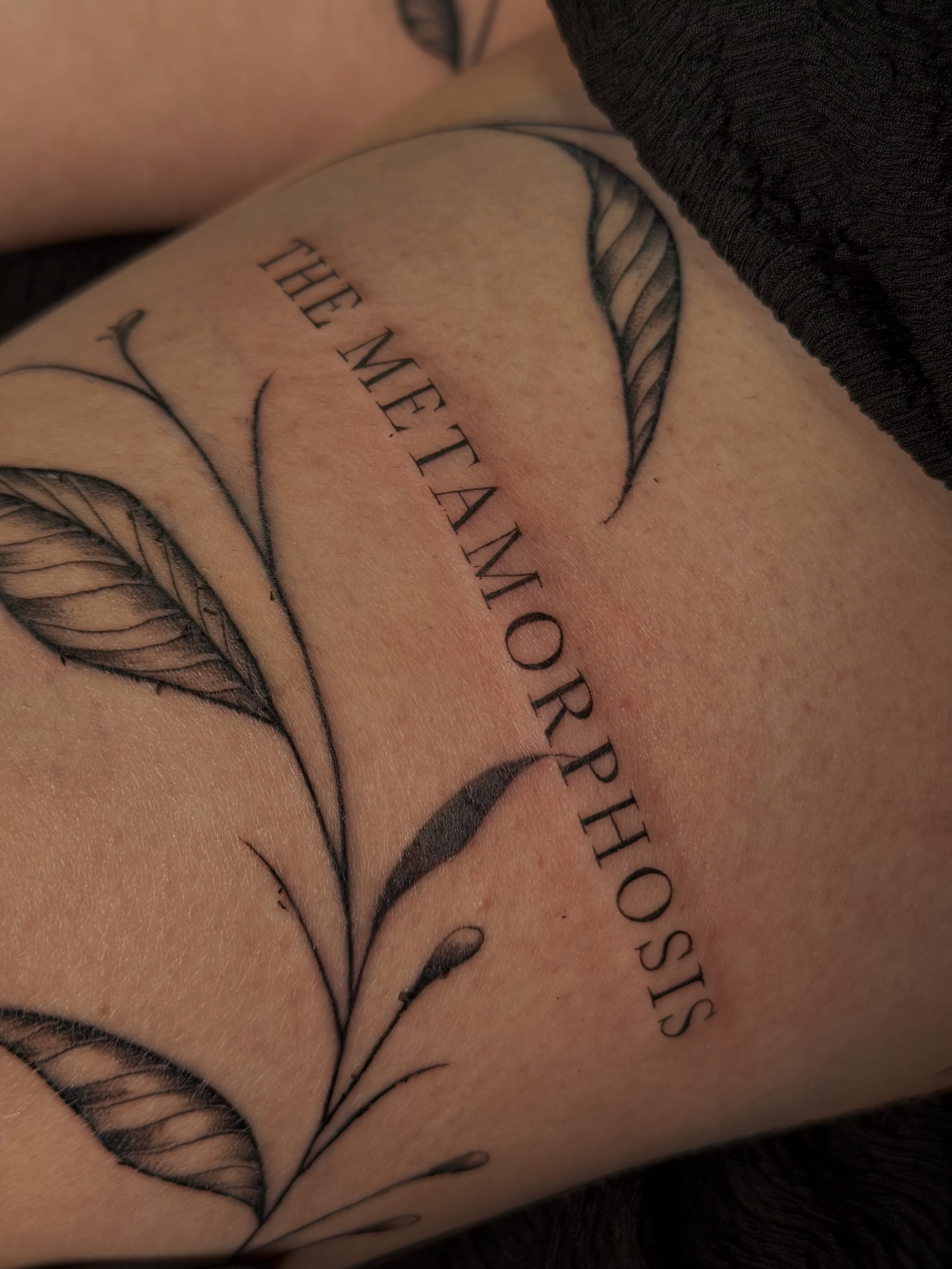 The metamorphosis black and grey tattoo on the forearm by Elisha Kane