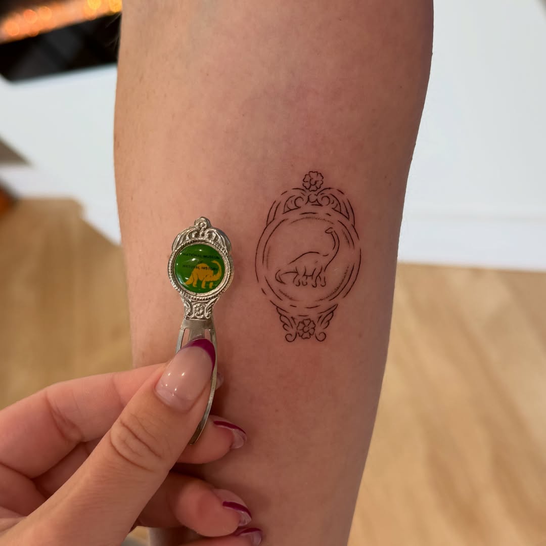 Dinosaur geometric tattoo on the forearm by Fine Line Tattoos