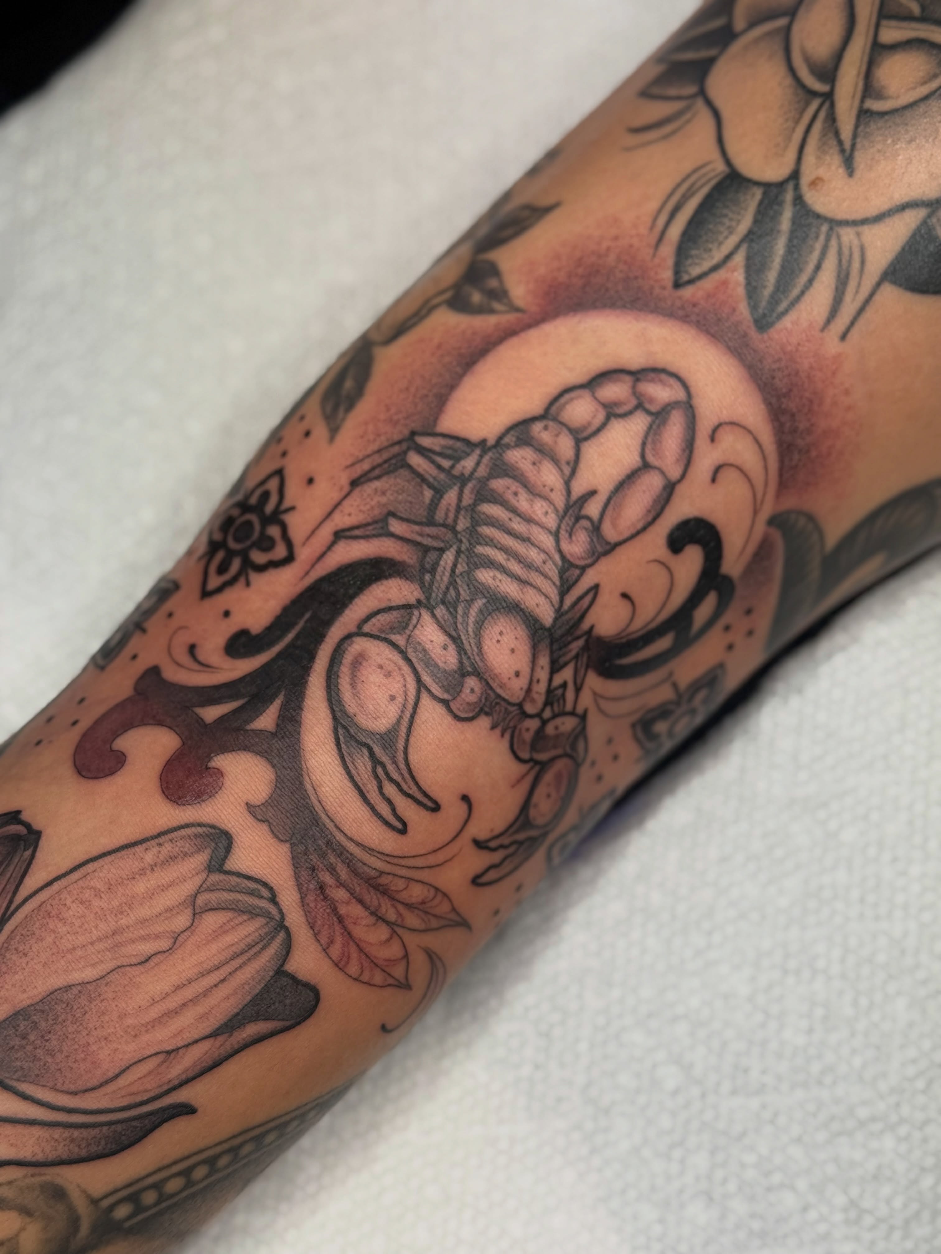 Scorpion and floral American traditional tattoo on the forearm by K9
