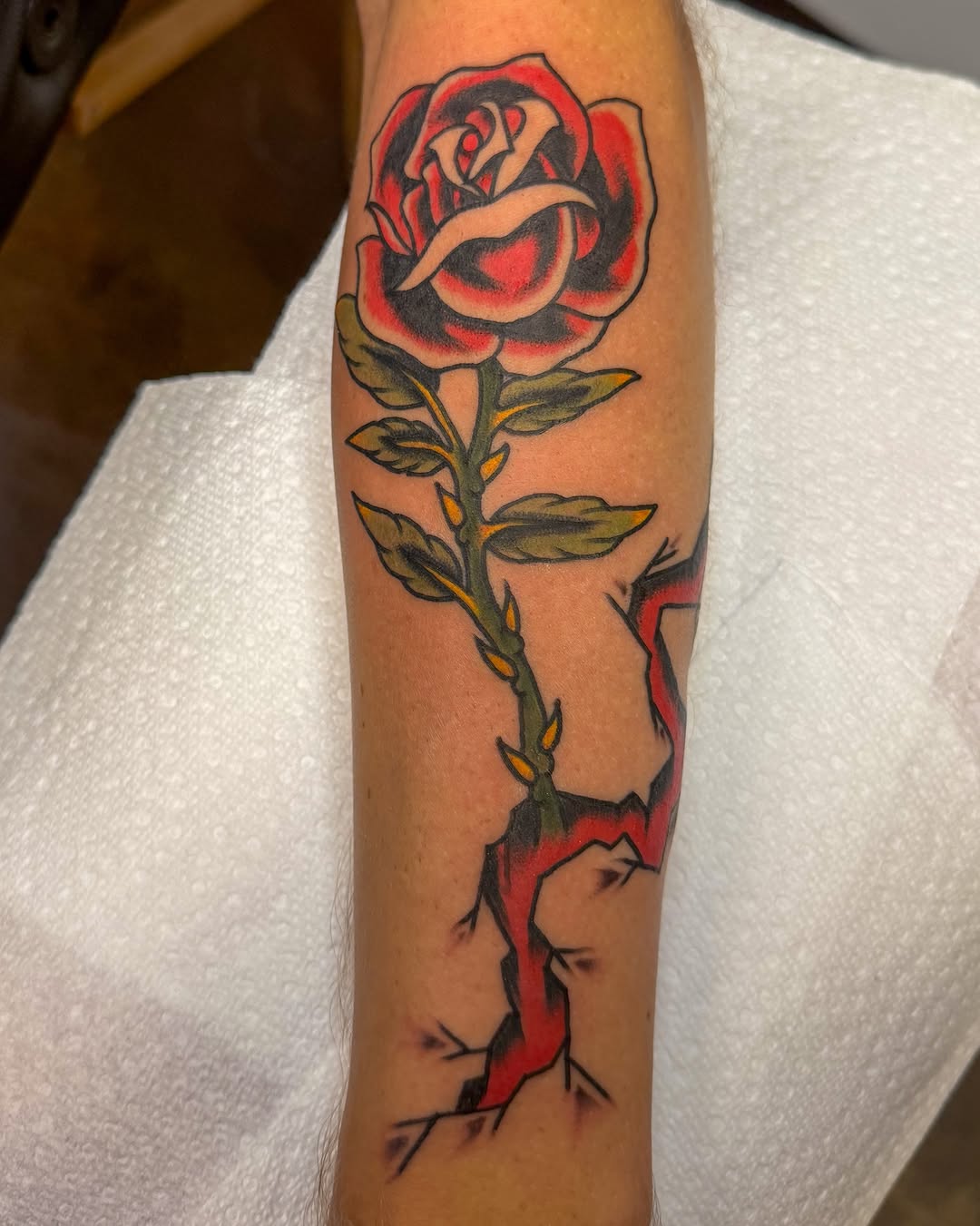 Rose American traditional tattoo on the forearm by Zac Tattooer