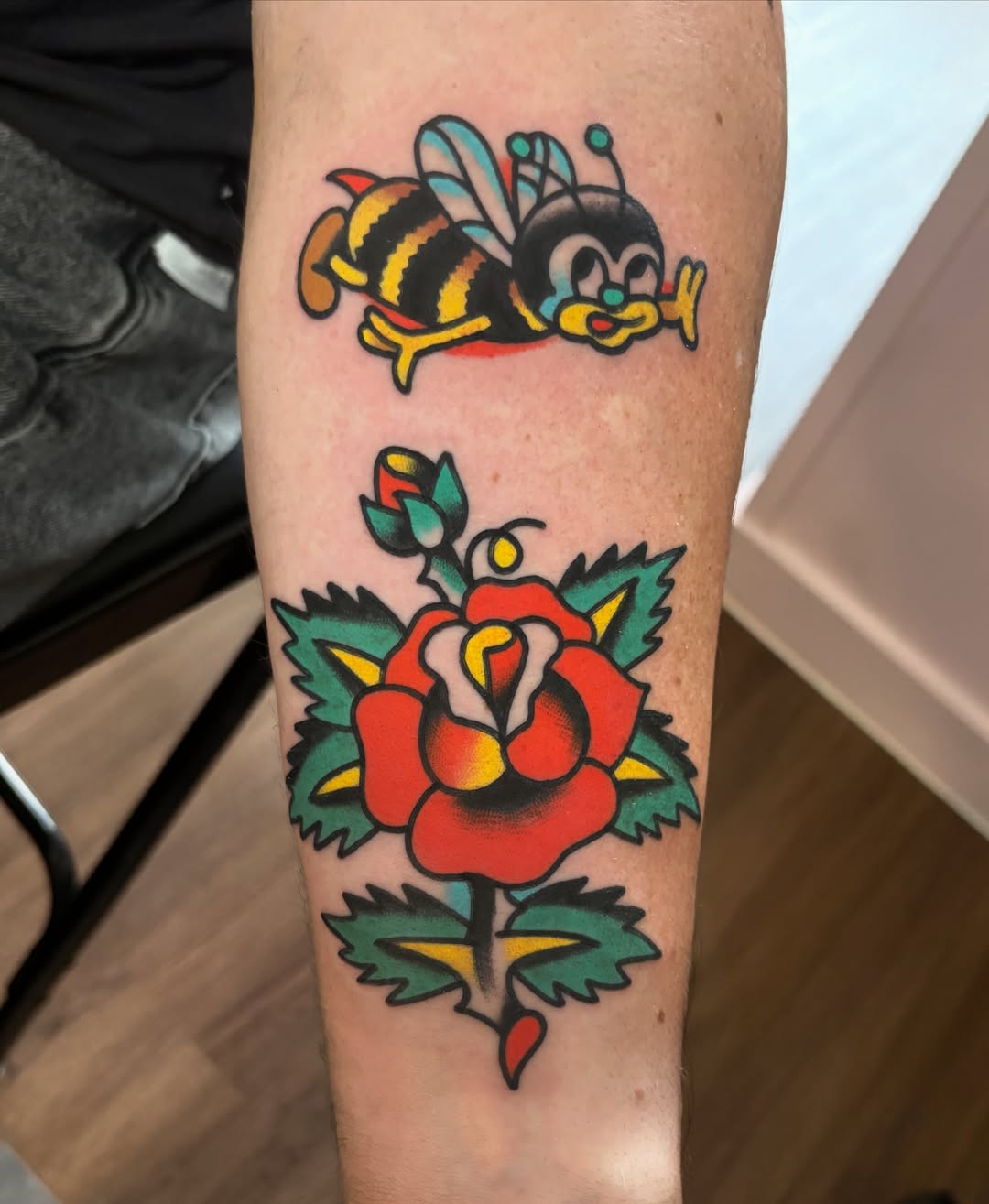 Bee and rose American traditional tattoo on the forearm by Traditional Tattooing